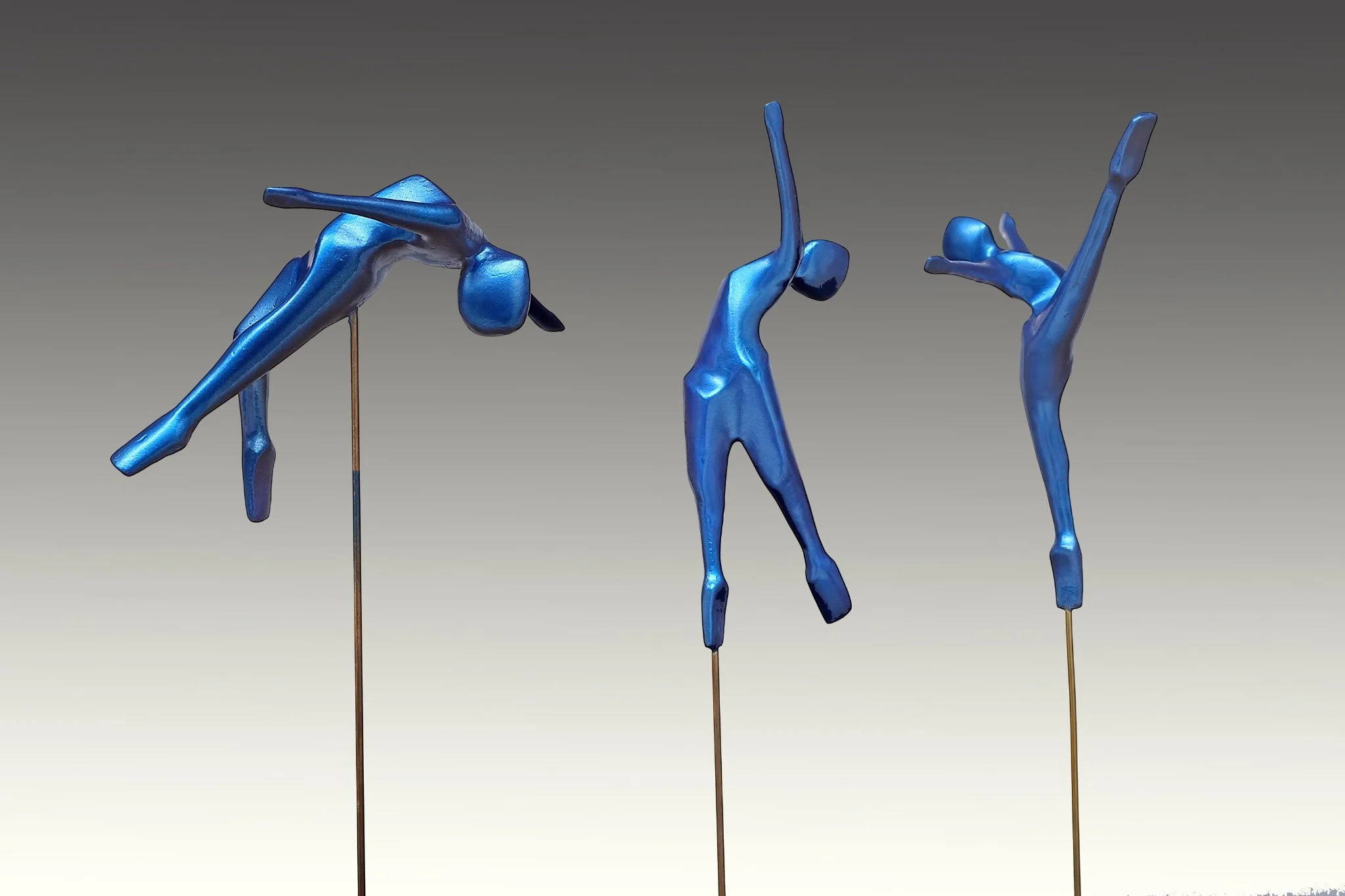 "Aerial Dancers" 20"x3"x3" each, PETG sculpture with Bahama Blue finish, suspended on wire on granite base. Each sold separately.