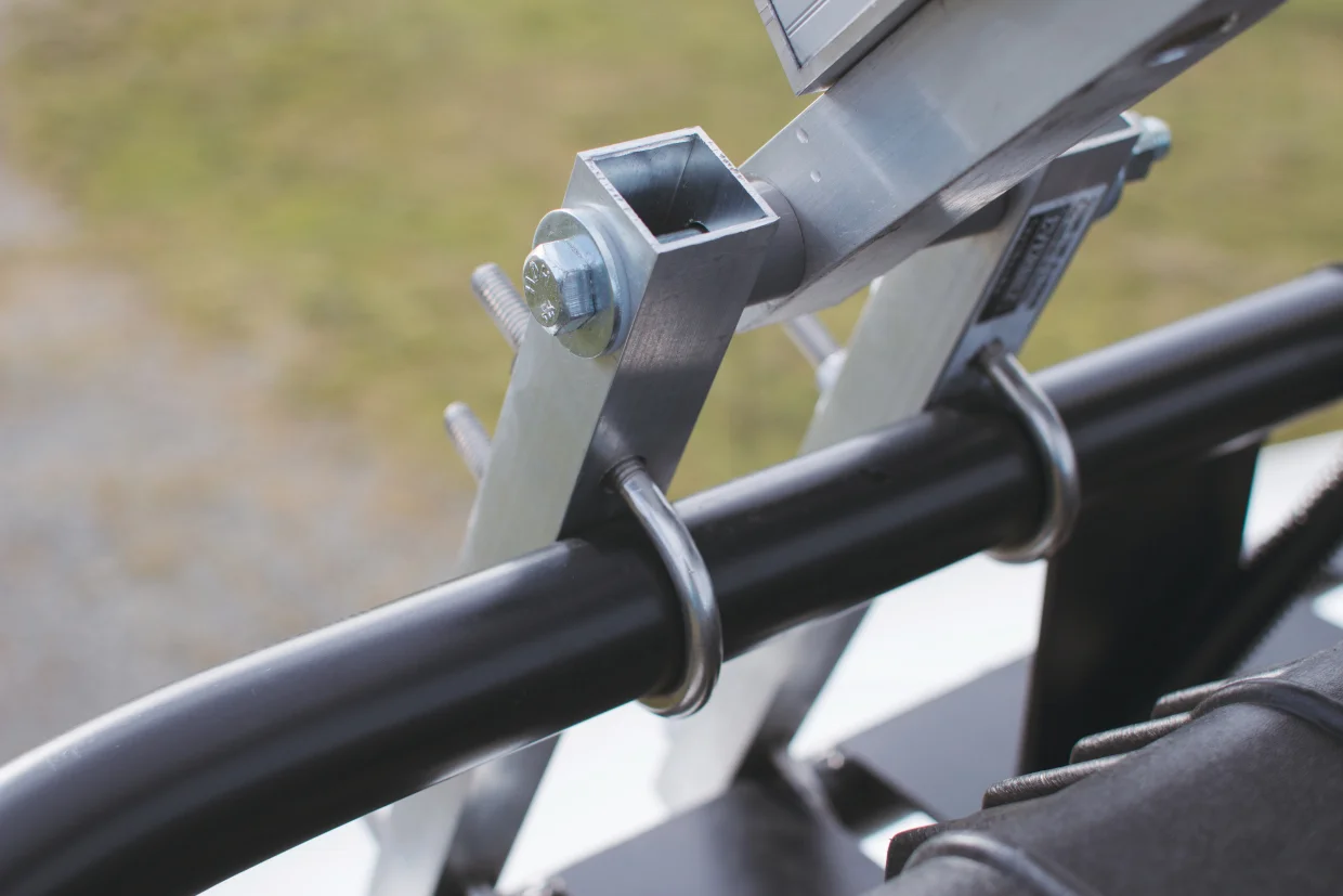 This is the large, custom hinge that Shane created with U-bolts and some steel tubing. The frame for the solar panels came in handy for this part as well.