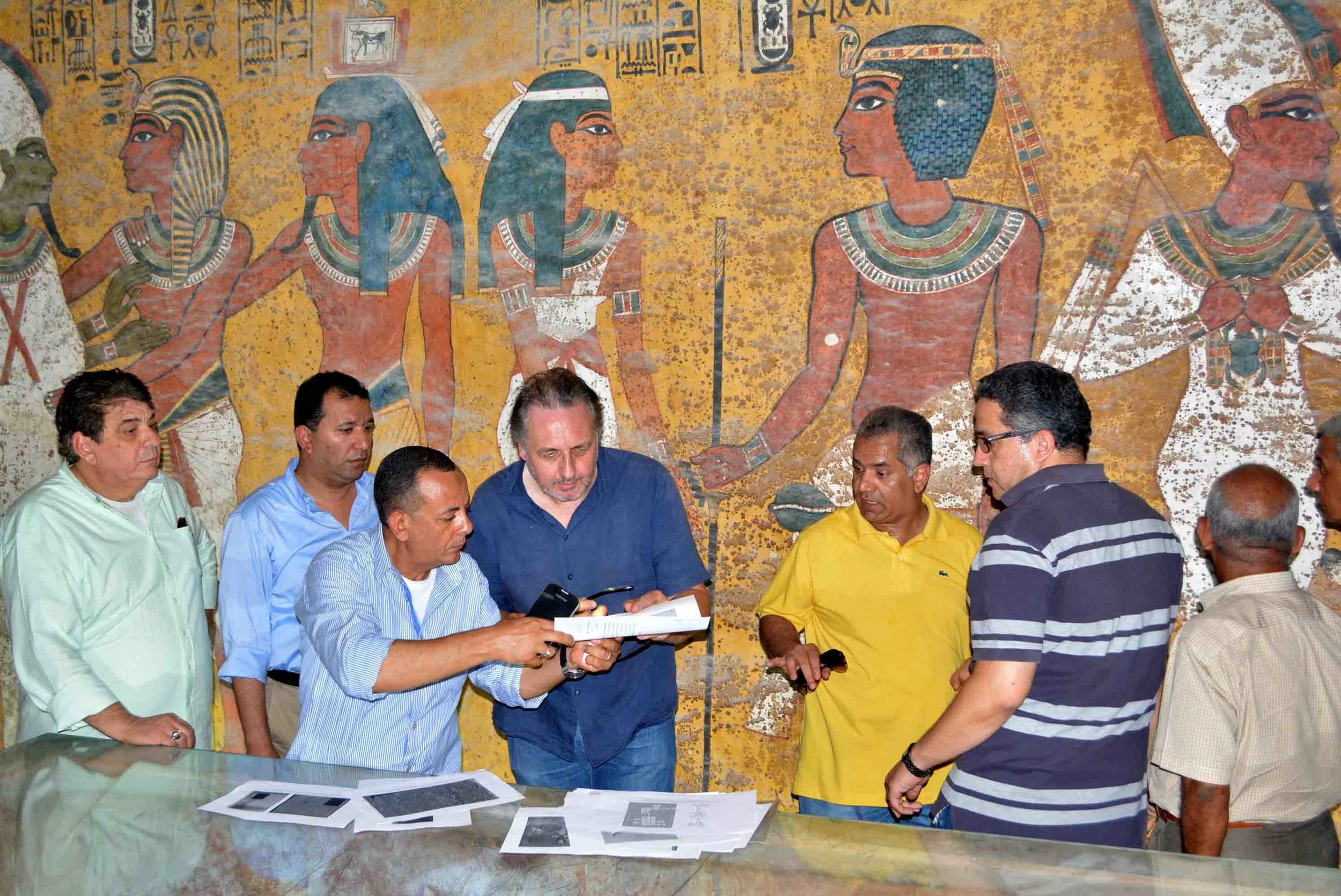 Examination of the burial chamber of King Tutankhamun by Nicholas Reeves (centre) and Antiquities Minister, Mamdouh el-Damaty (in the yellow shirt). Photo: Nevine El-Aref.