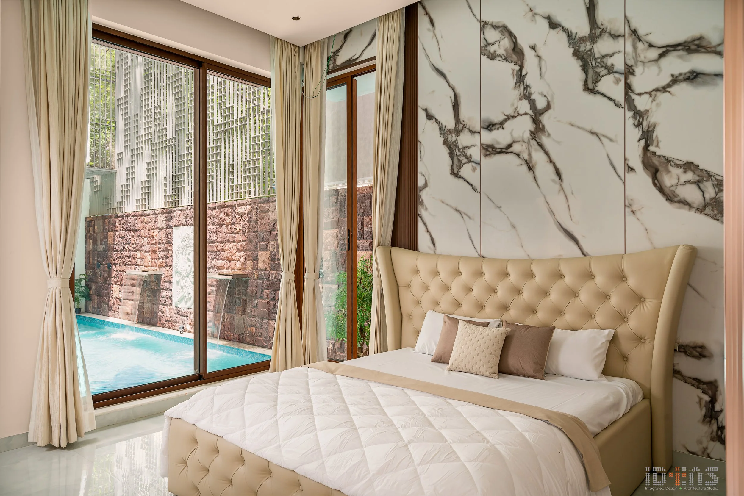 Master bedroom with a marble feature wall