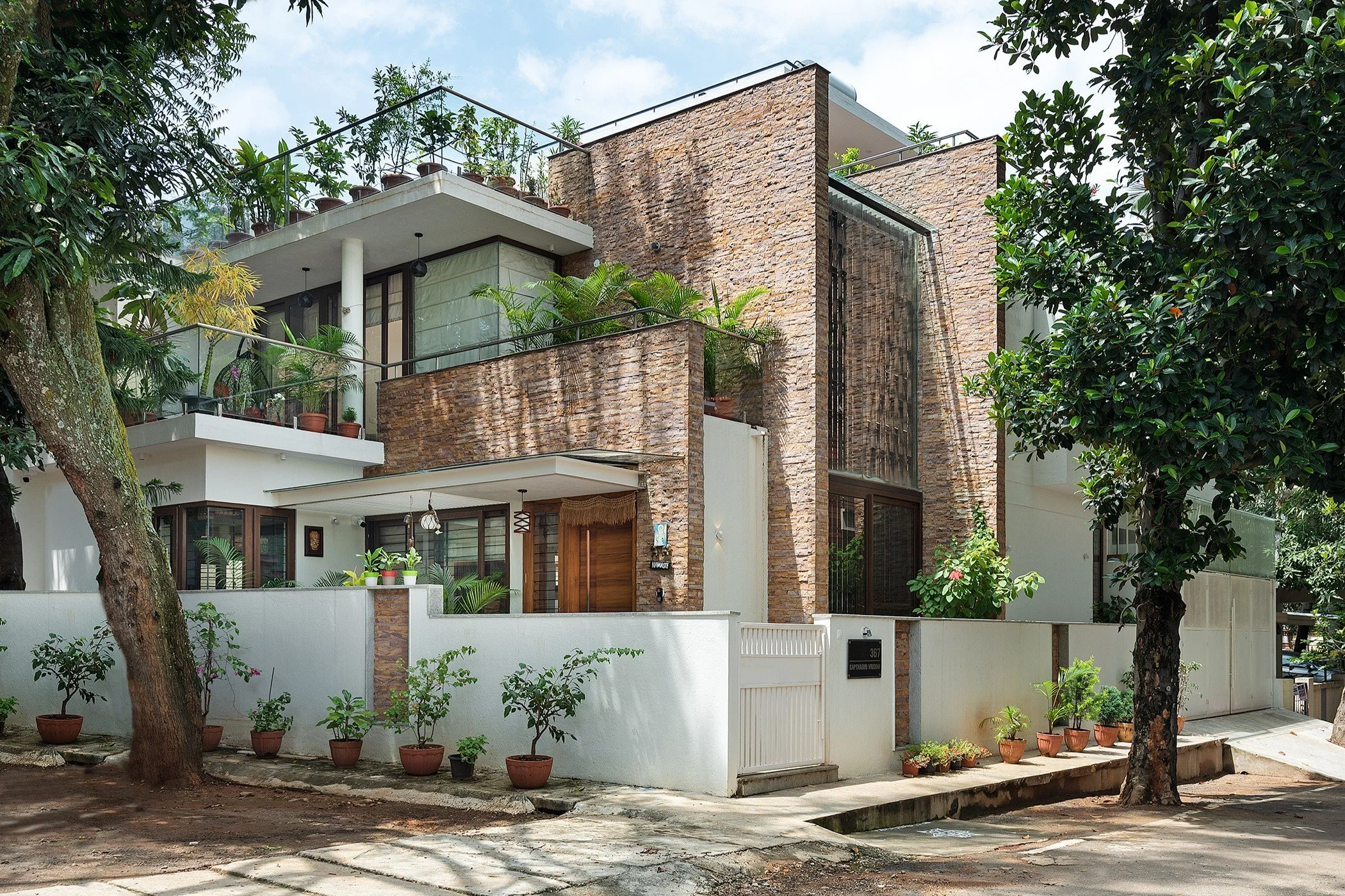 The house from the street: stone-clad volumes