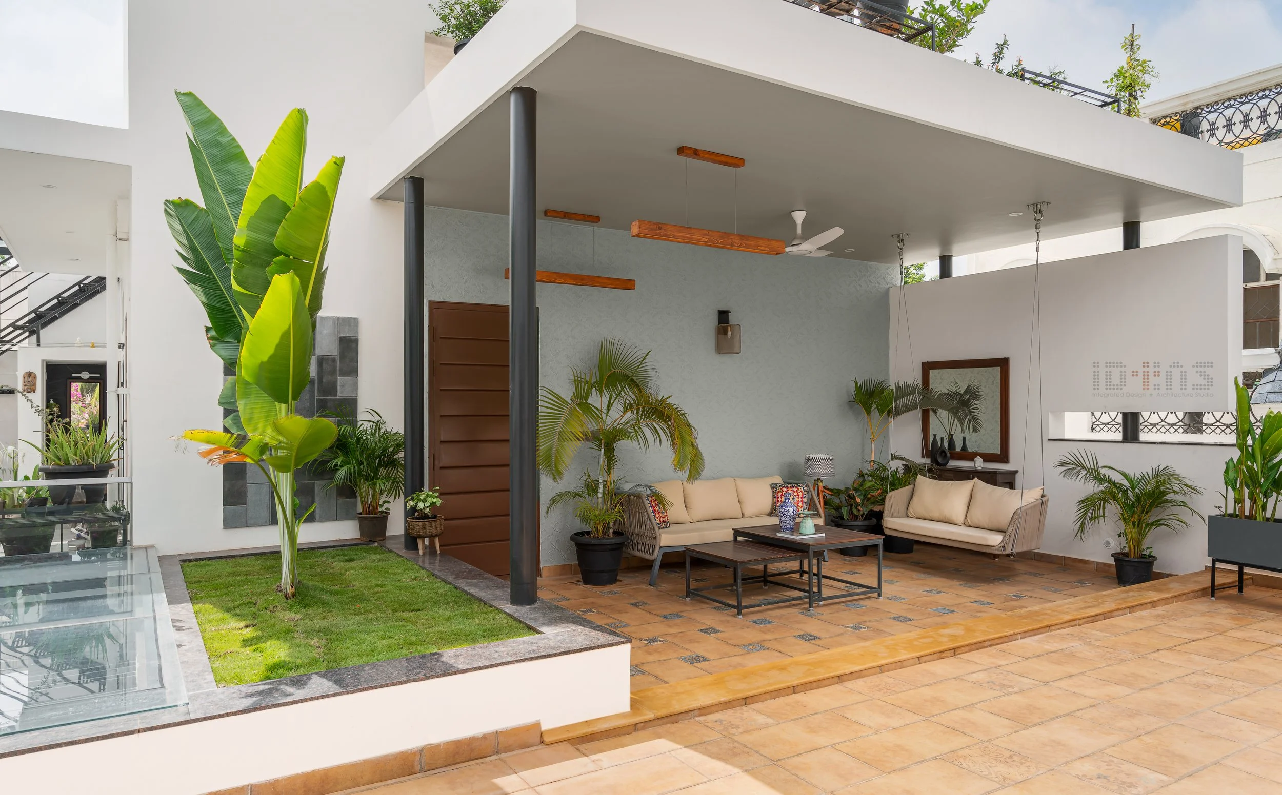 The waterbody and pergola-covered seating at the entrance