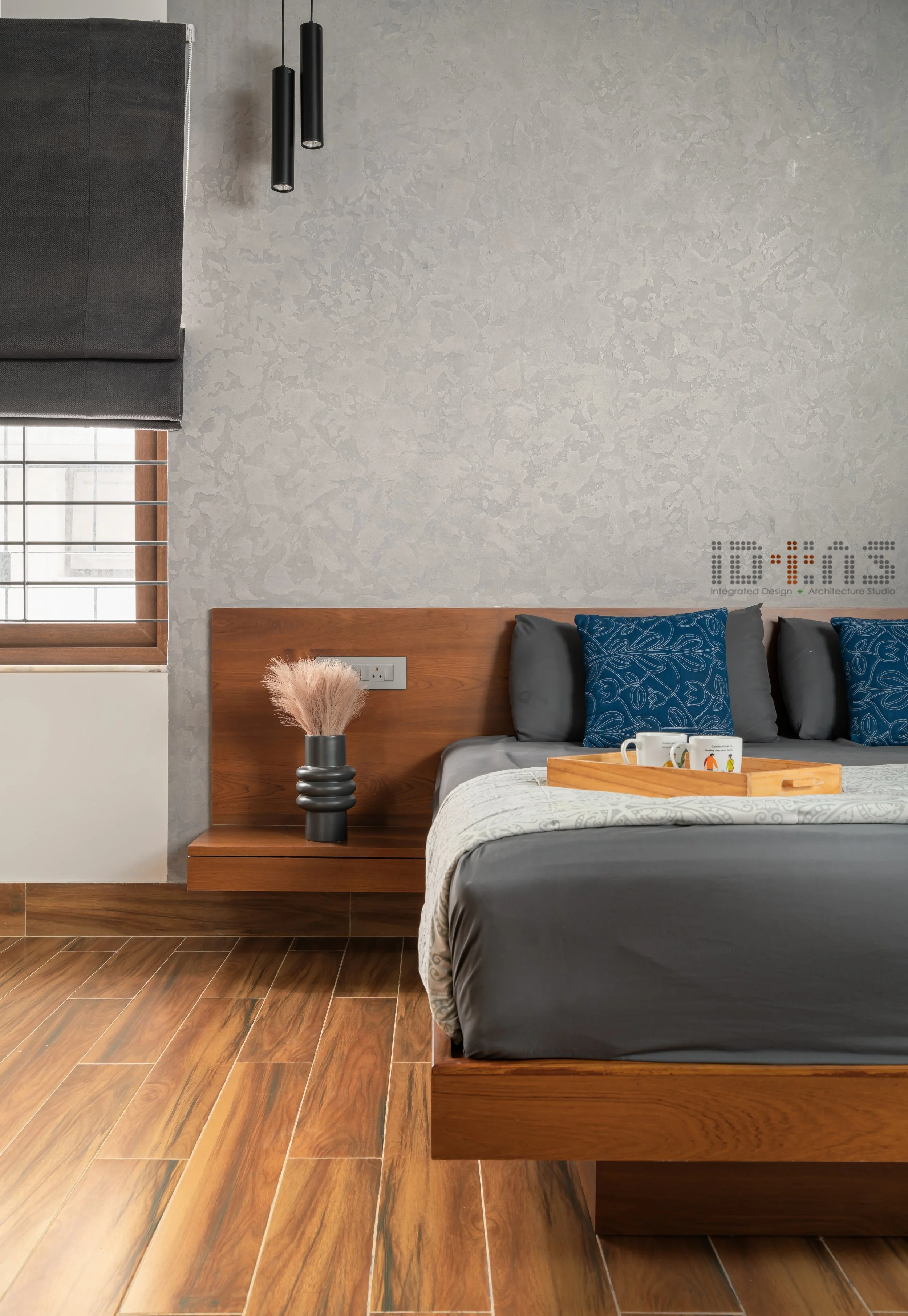 Bedroom with a grey wall and a timber bed