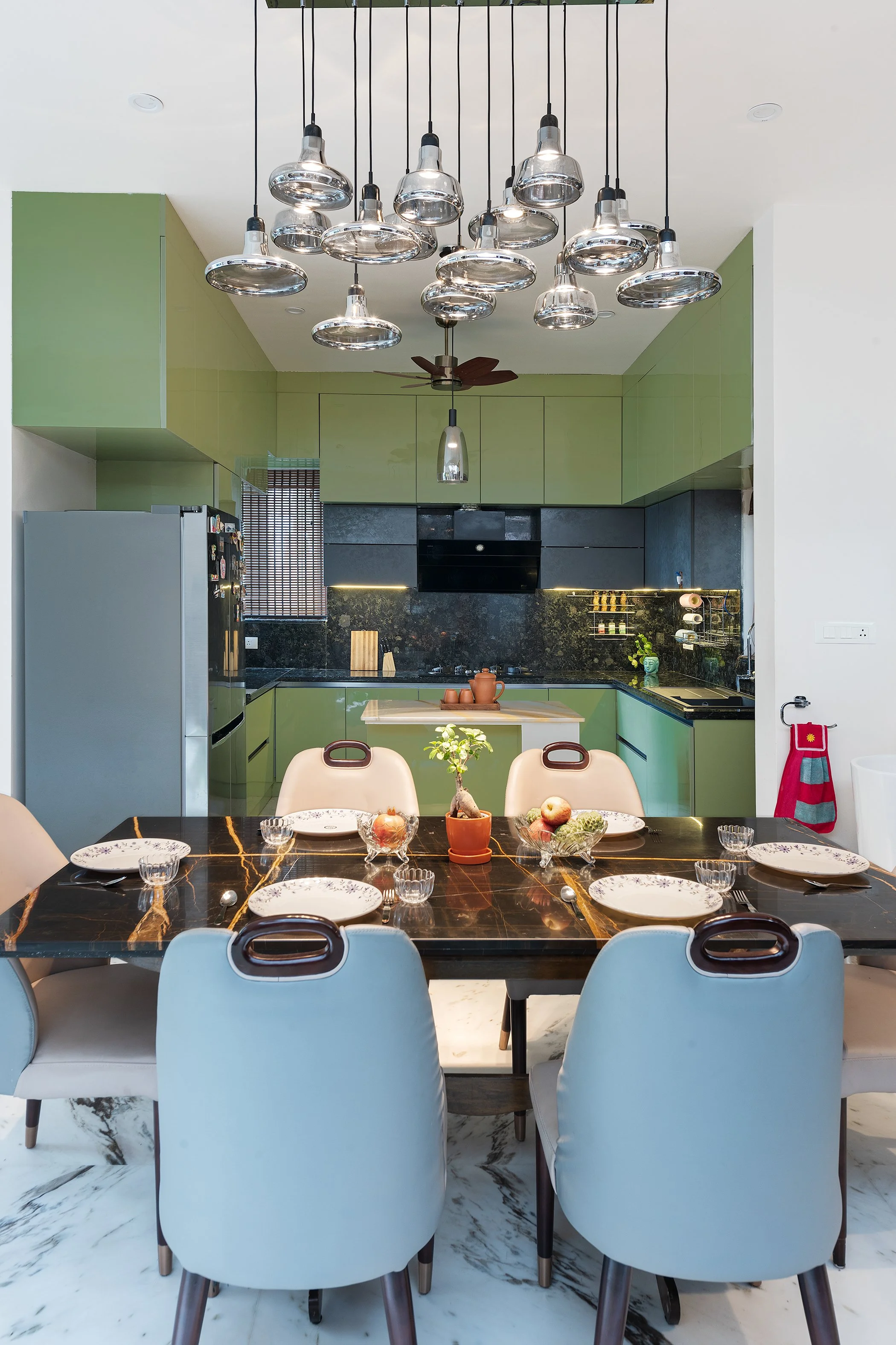 Dining room with a green wall and blue chairs