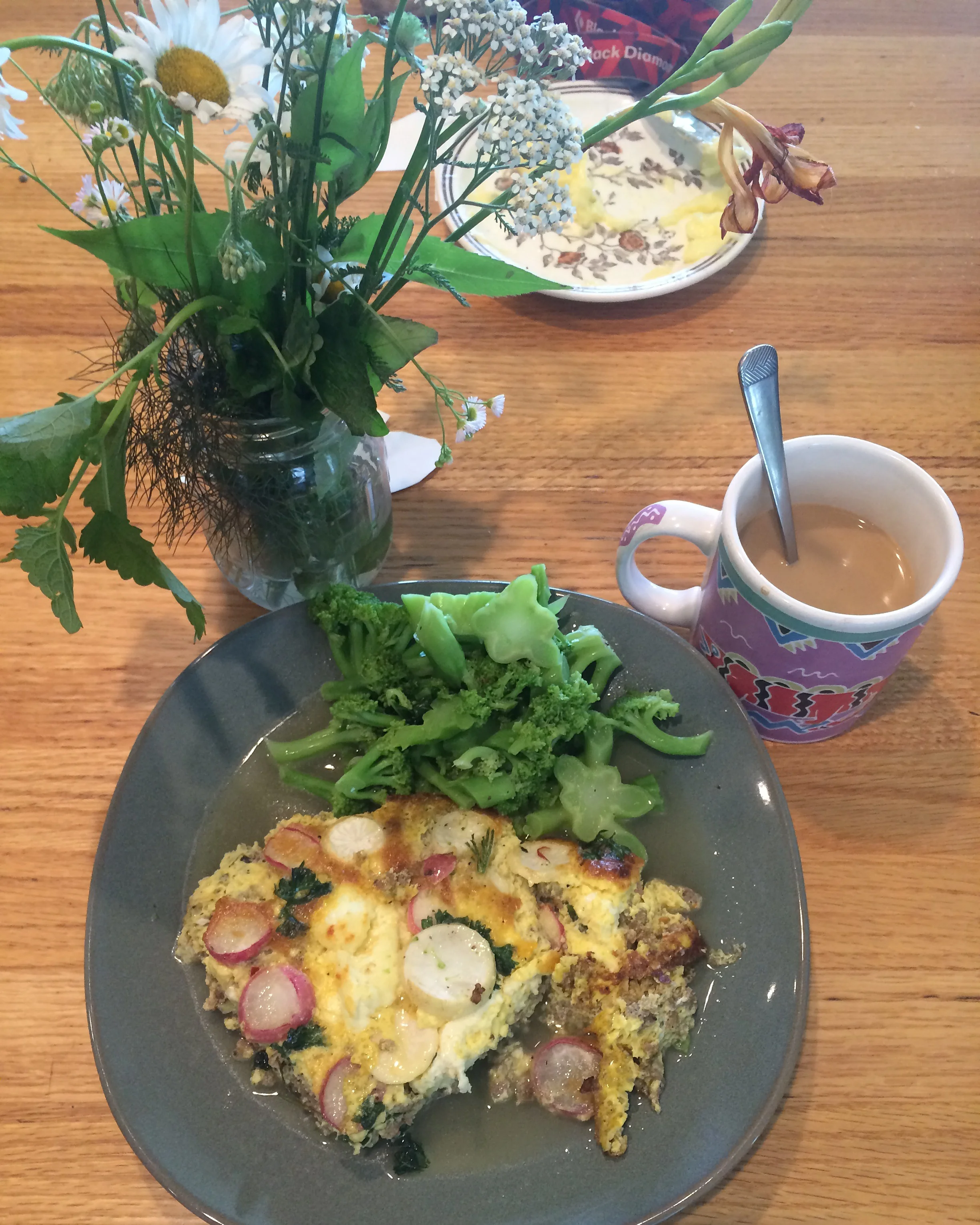 The non-vegetarian frittata I made with pork sausage, homemade cheese, garlic scapes, radishes, turnips, and parsley with steamed broccoli and butter. 