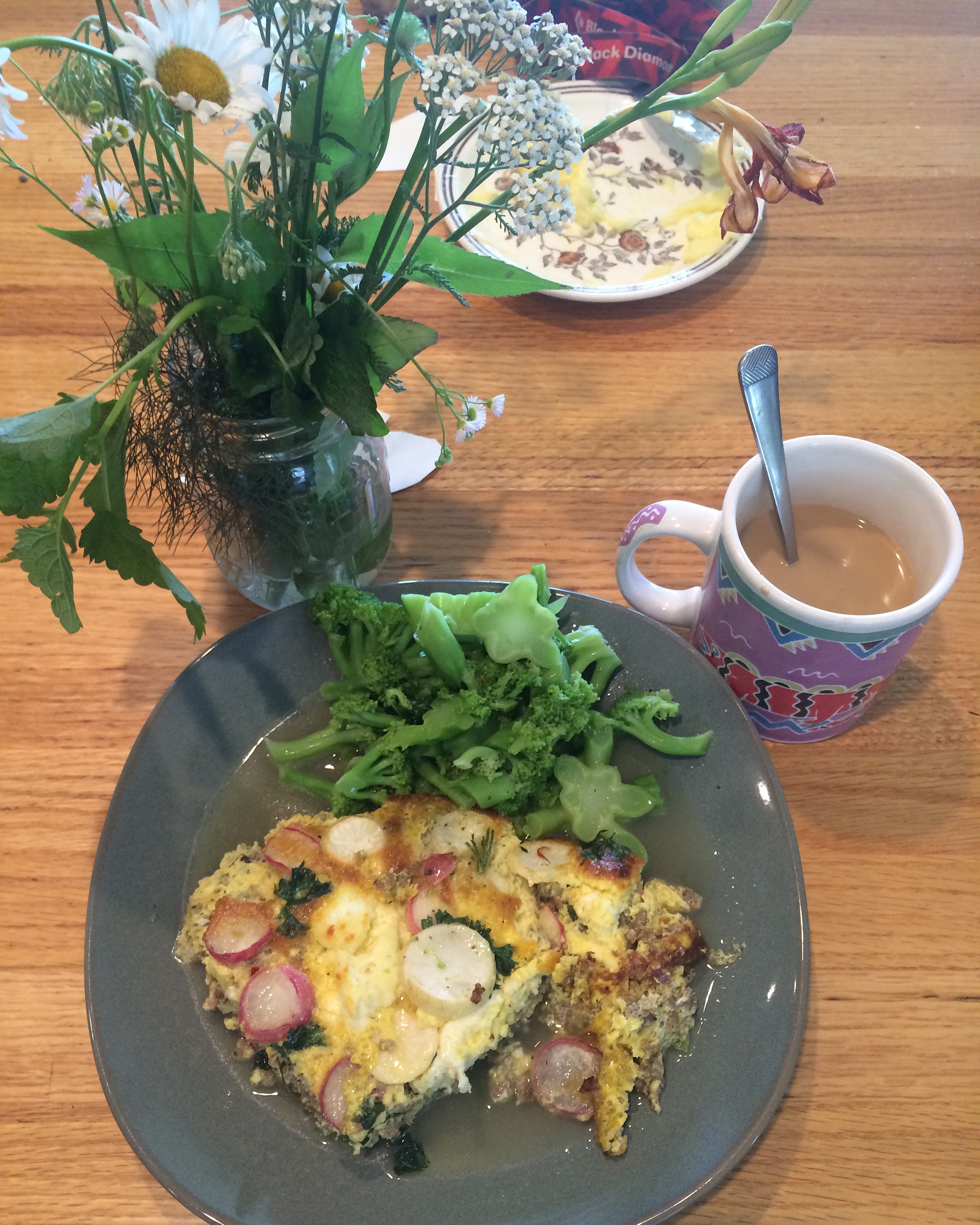 The non-vegetarian frittata I made with pork sausage, homemade cheese, garlic scapes, radishes, turnips, and parsley with steamed broccoli and butter. 