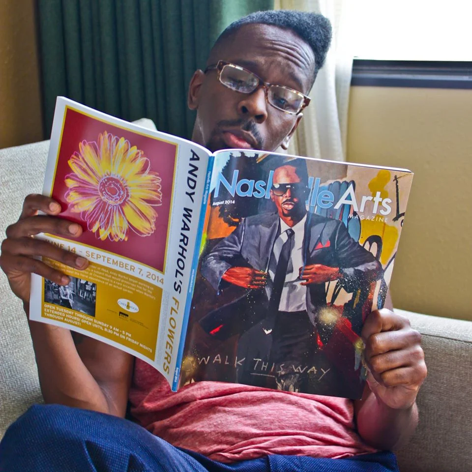 Visual Artist Fahamu Pecou checking out the article written about him in the Nashville Arts Magazine. Fahamu was the first African American artist ever featured on the cover of Nashville Arts Magazine. A testament to the quality of his work. His exhibition, held at The Arts Company, was part of a 5-day arts and culture festival curated by Beatrix Moss' Leatrice Ellzy in Nashville. 
