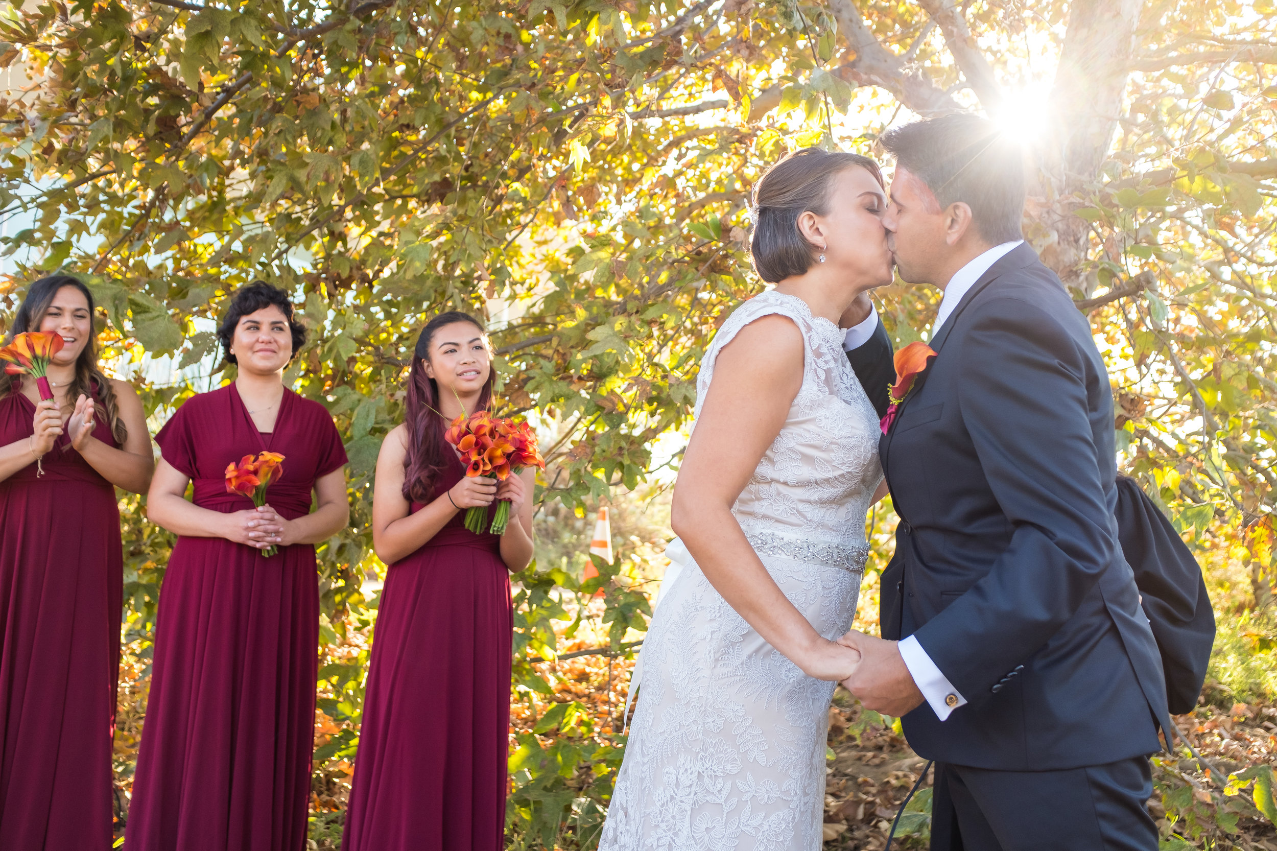 bride and groom kiss at a wedding in Baldwin Hills Scenic Overlook