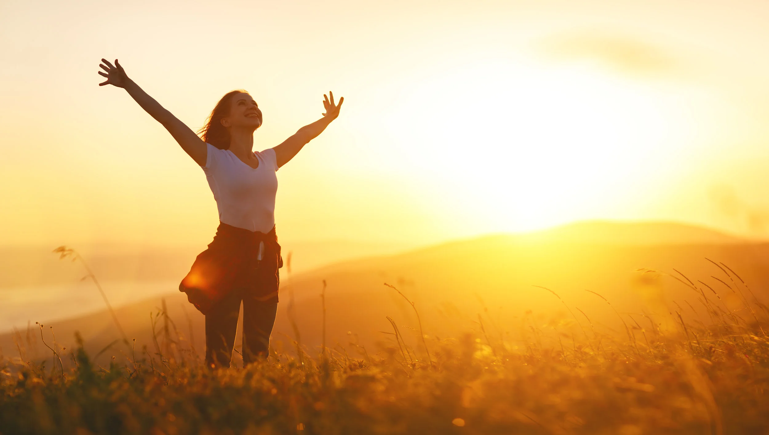 Happy-woman---on-sunset-in-nature-iwith-open-hands-836685320_6449x3648.jpeg