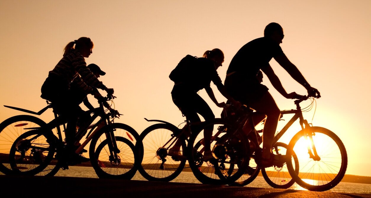 Silhouettes-of-friends-riding-bicycles-at-sunset-176808352_1258x839.jpg