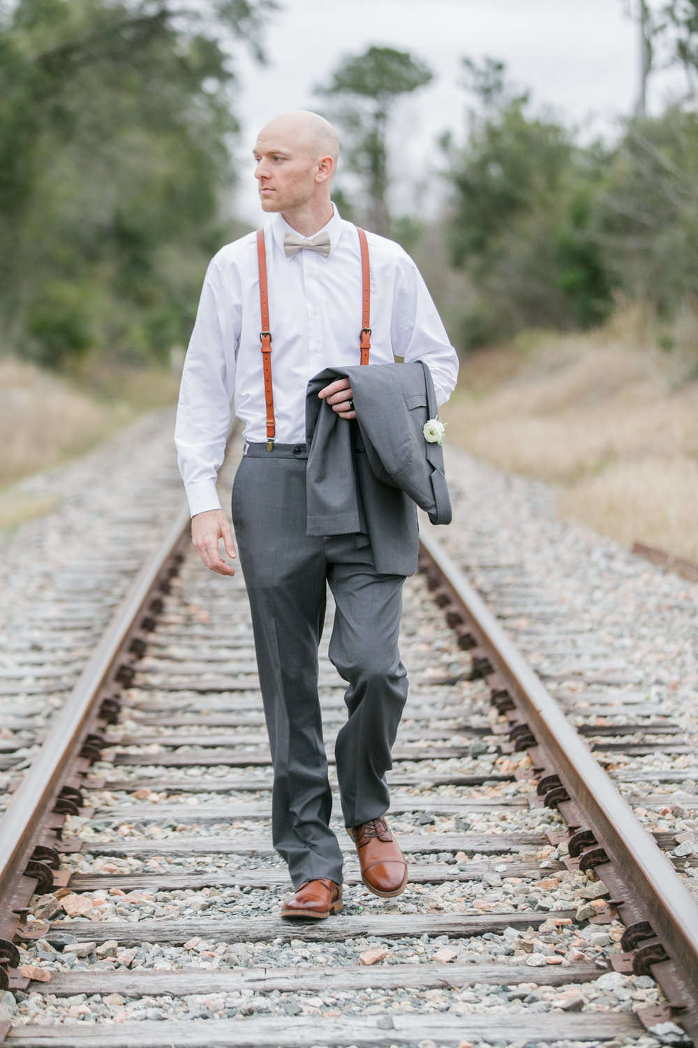 groom portraits train track.jpg