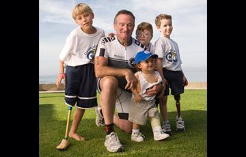 Ezra, 1-year-old, with Robin Williams and other athletes