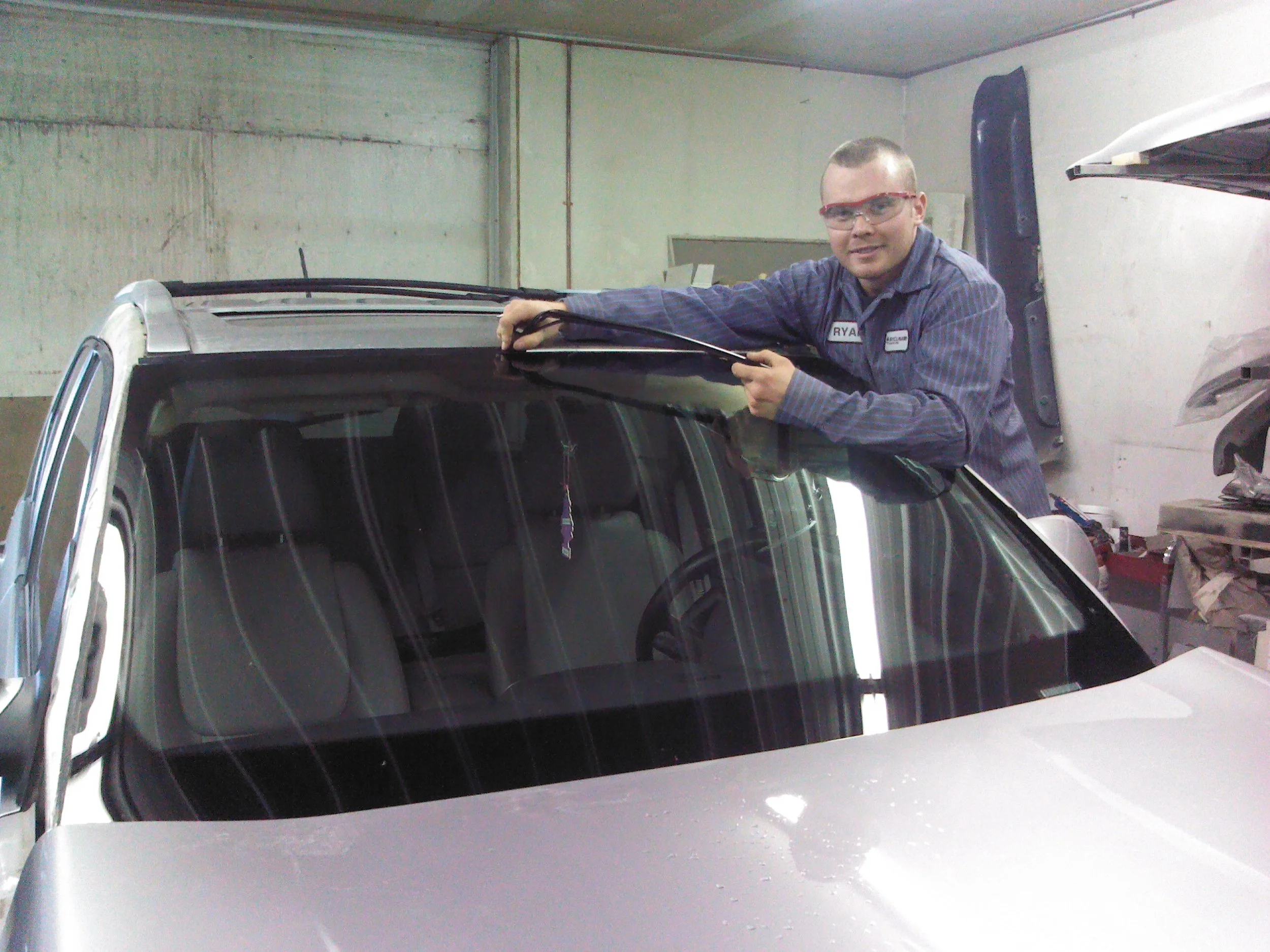 Ryan changing a windshield on a customers vehicle in our old shop in February of 2012.