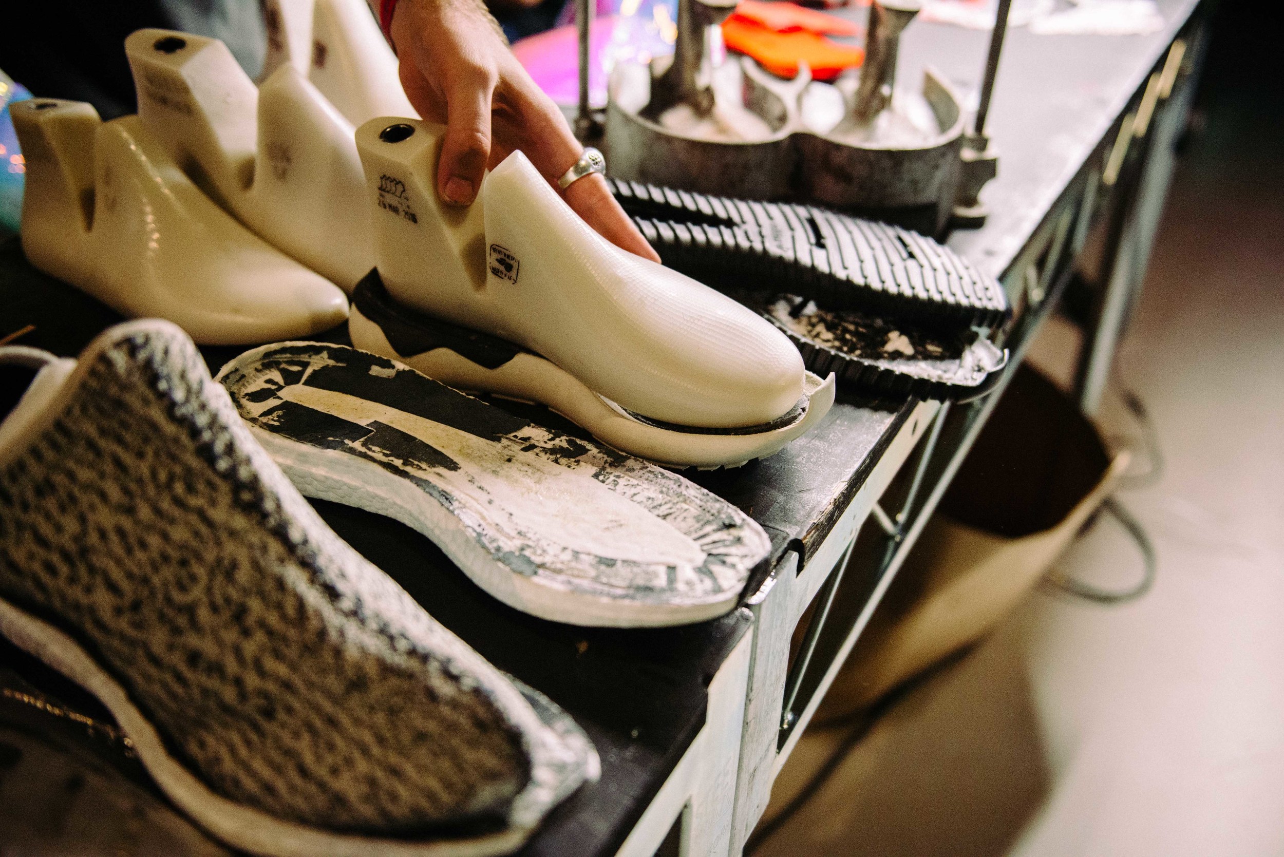  The Shoe Surgeon customizing soccer cleats at Adidas' Mercury Center. / Photo: © Diane Abapo for SUSPEND Magazine. 