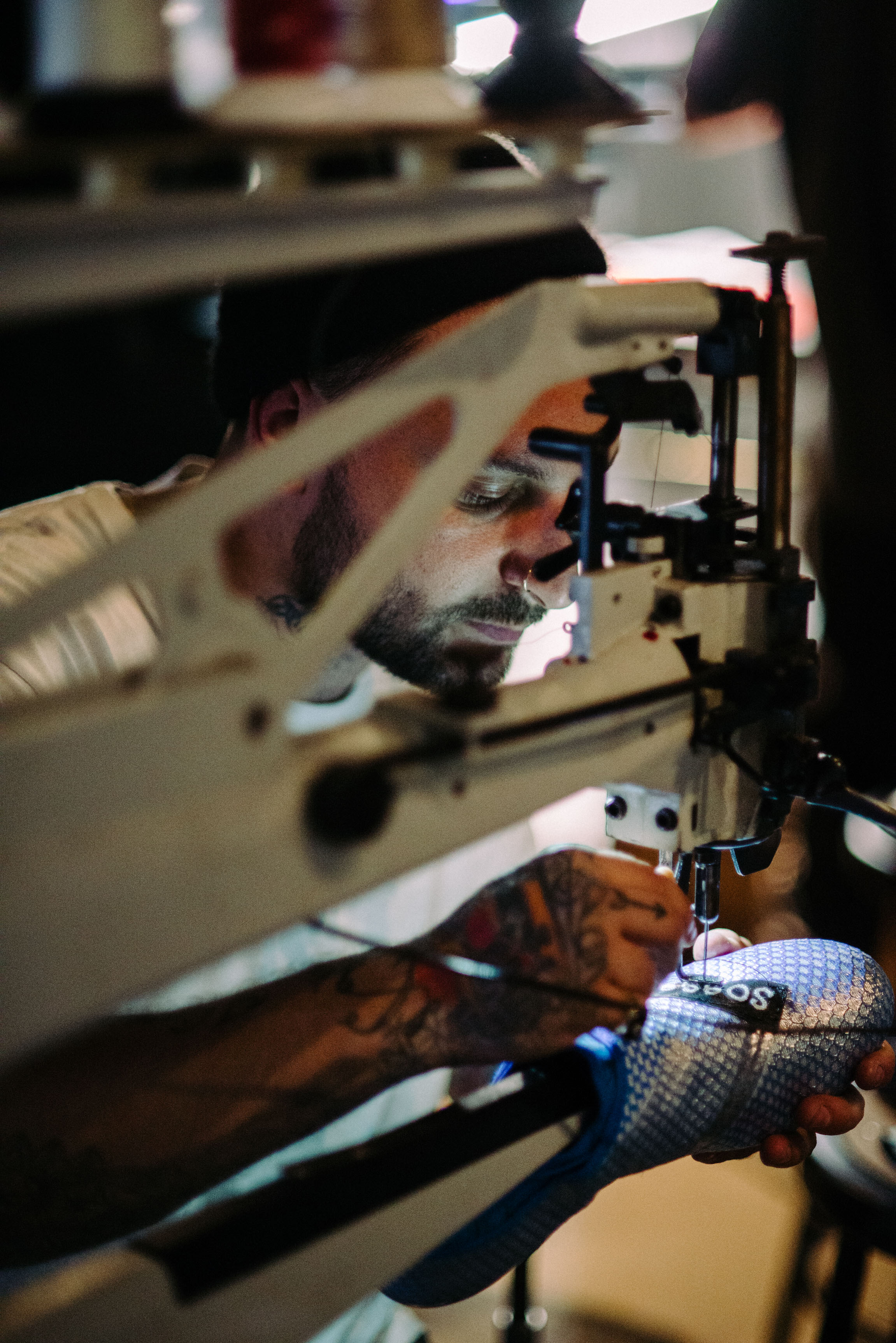  The Shoe Surgeon customizing soccer cleats at Adidas' Mercury Center. / Photo: © Diane Abapo for SUSPEND Magazine. 