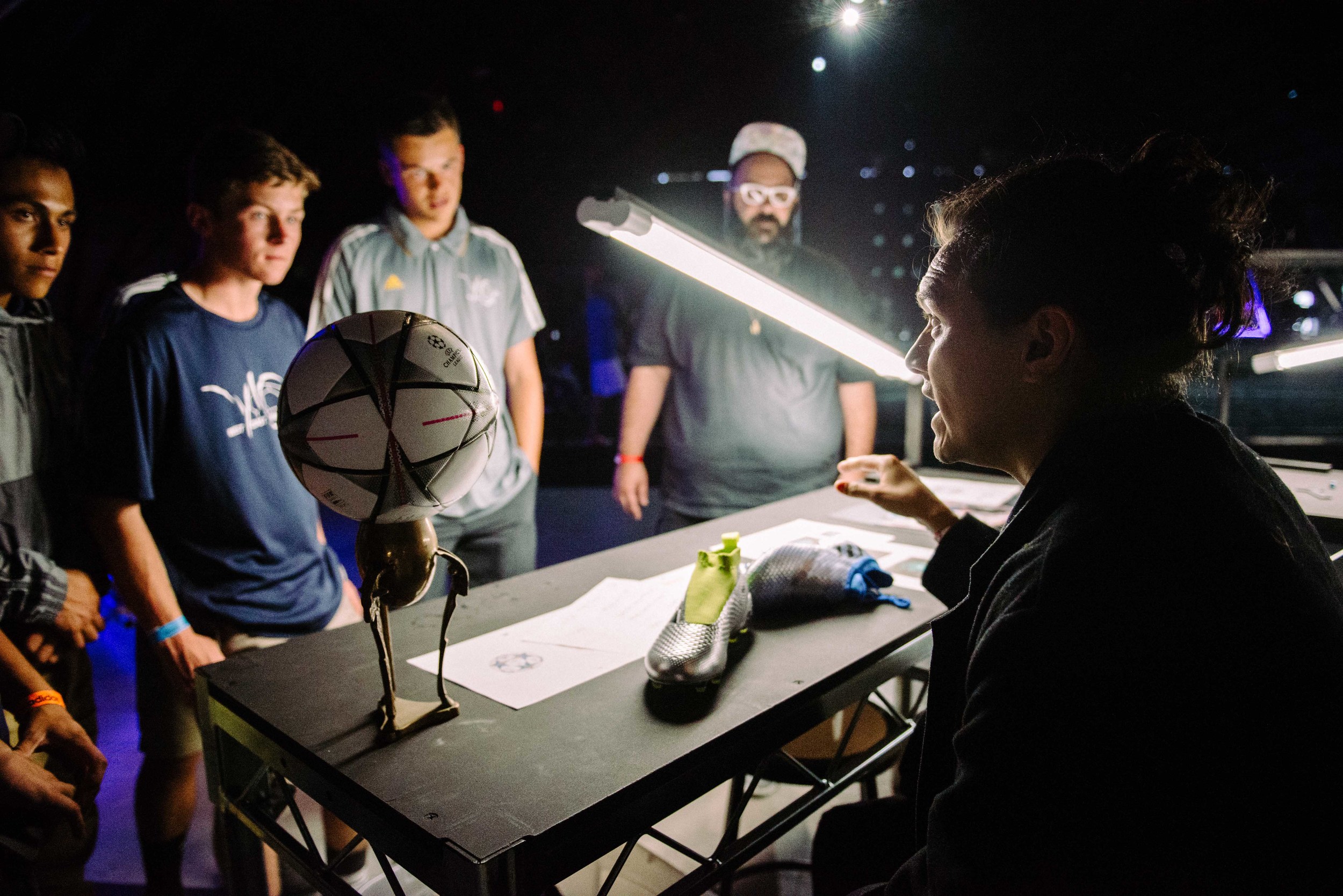  Custom jeweler Guillermo Andrade, owner of FourTwoFour on Fairfax, discusses his custom jewelry pieces with young athletes at Adidas' Mercury Center.&nbsp;/ Photo: © Diane Abapo for SUSPEND Magazine. 