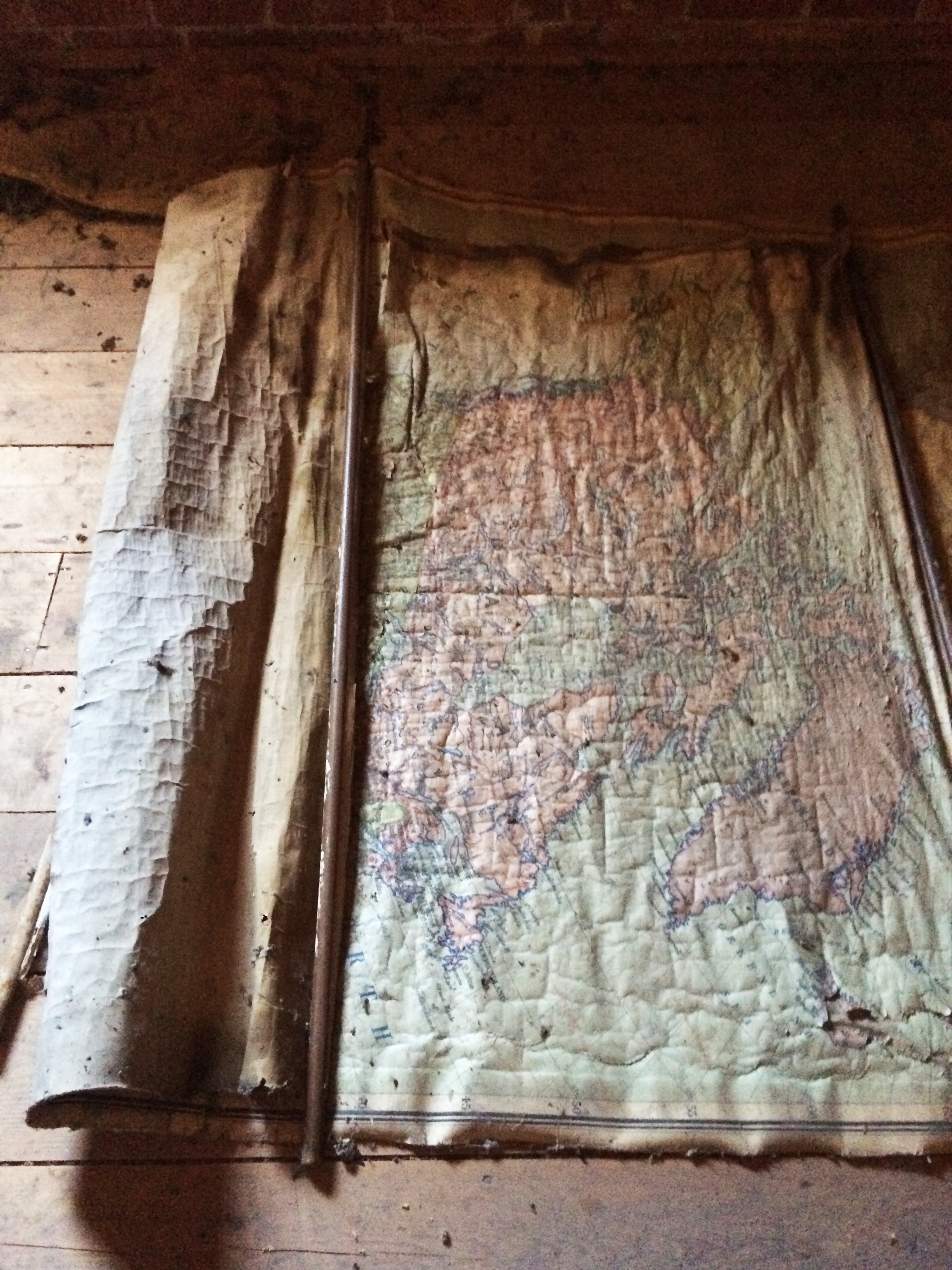 An old map of the world in the attic of a former school building