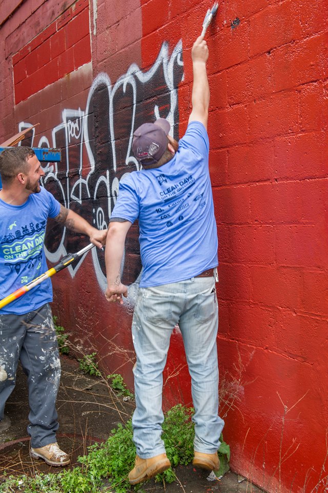 Volunteers cleaning the tags off the building during the Clean Up Day in April. Photo taken from https://www.facebook.com/WRWCRI/