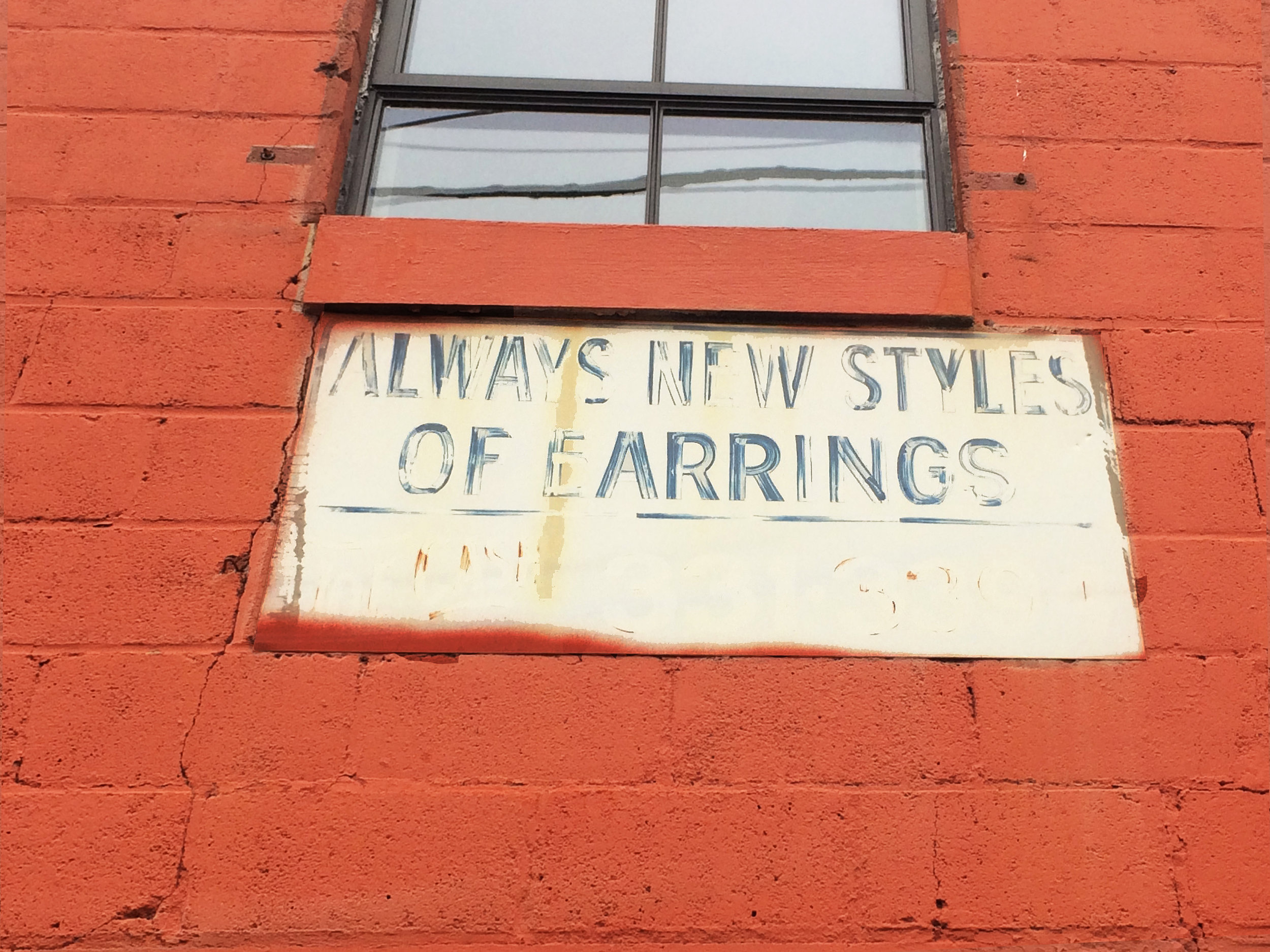 "ALWAYS NEW STYLES OF EARRINGS" Still reads on one of the walls from the time the buidling was a storage for costume jewelry, a testament to its layered history