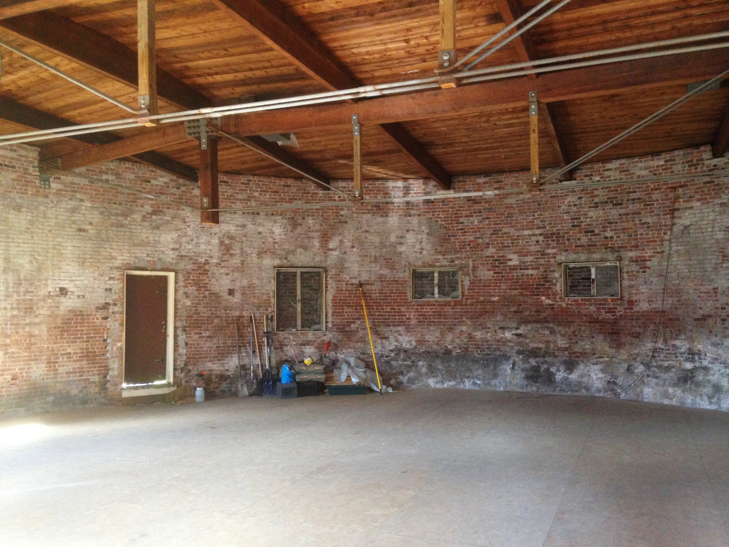 One can see where a column was "cut" short and restructured within a metal truss under the ceiling to create a completely open circular floor plan
