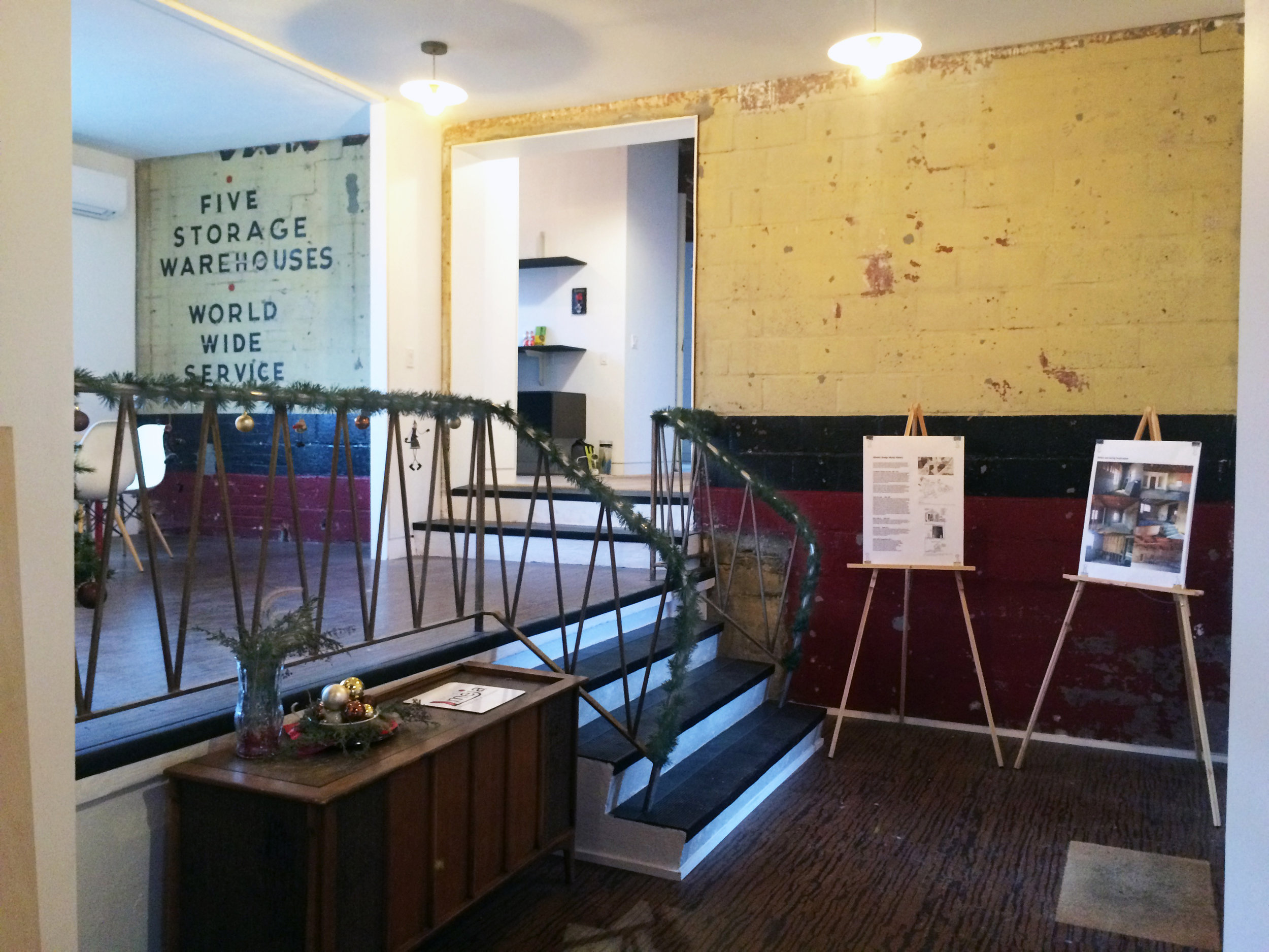 This area, now exhibiting some of its historical signage, with new floors, finishes, fixtures, and treads now serves as the "lobby" and conference area into the Atlantic Designworks. 