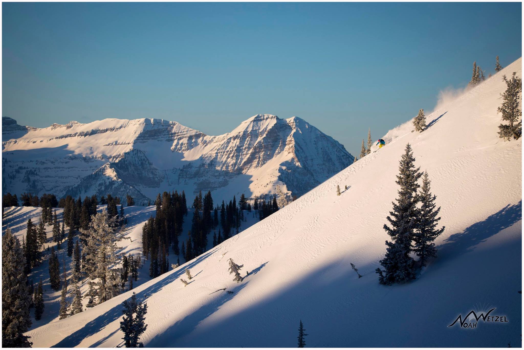 PORTFOLIO IMAGE 1 of 9 LUCY SACKBAUER skiing at sunrise in the Brighton Resort sidecountry with the stunning Mt. Timpanogos looming in the distance! 