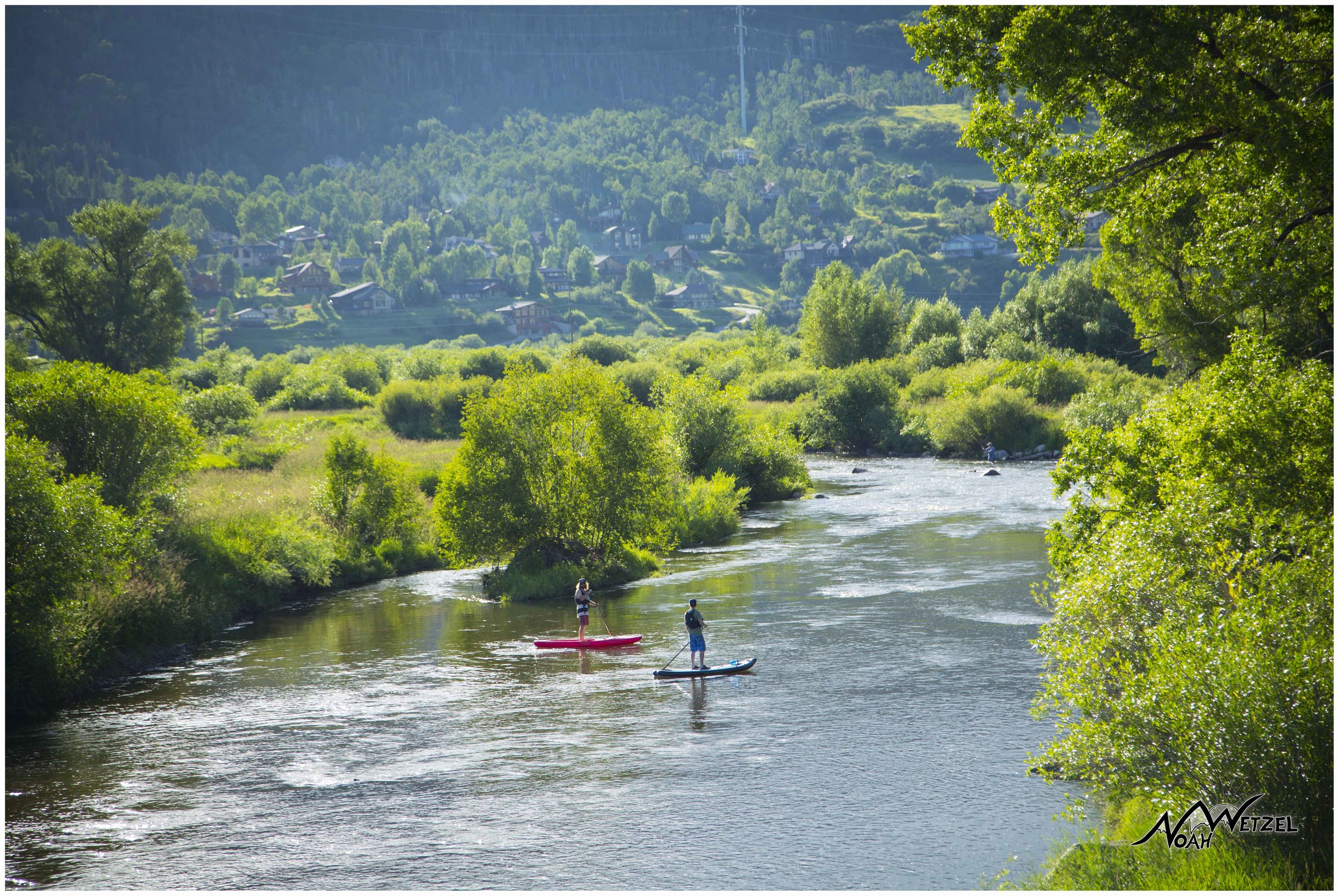 Mike Rundle and Marty Smith paddle-boarding the Yampa River. Colorado