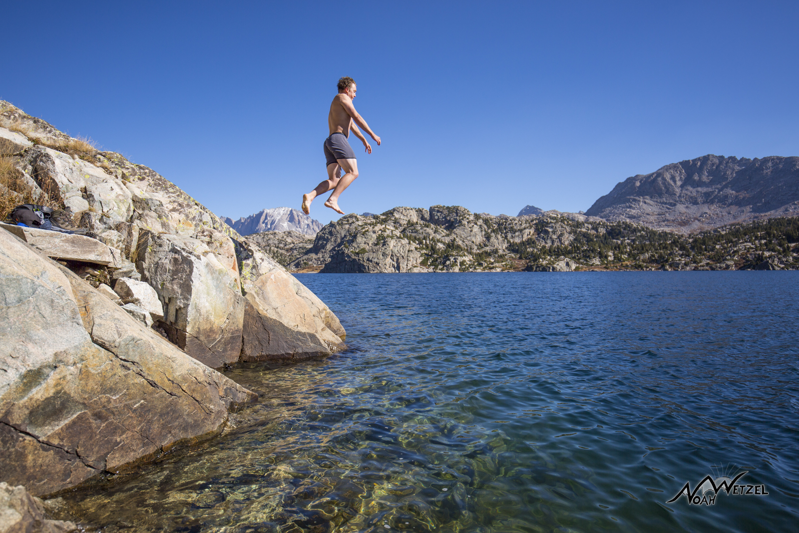 Ben Wetzel jumping into Seneca Lake in late September in the Wind River Range. Wyoming. 