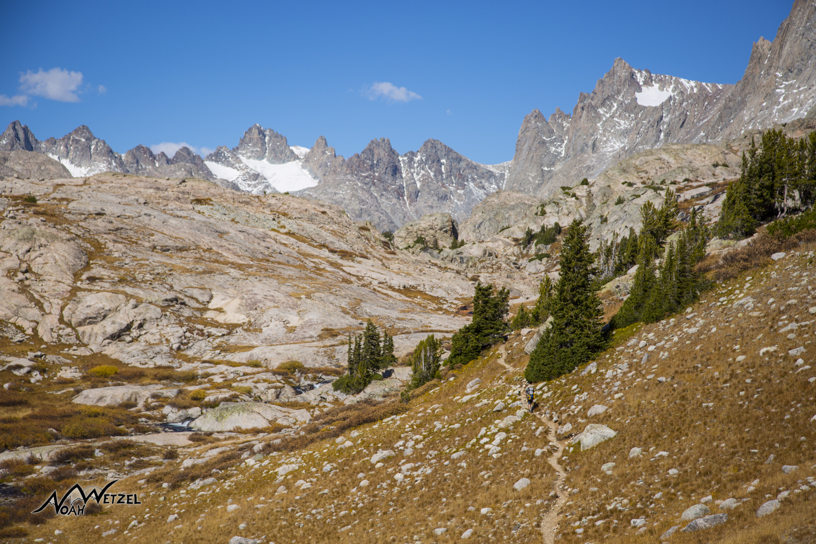 Ben hikes up the Indian Basin Trail with Titcomb Basin looming in the distance. Wind River Range. Wyoming