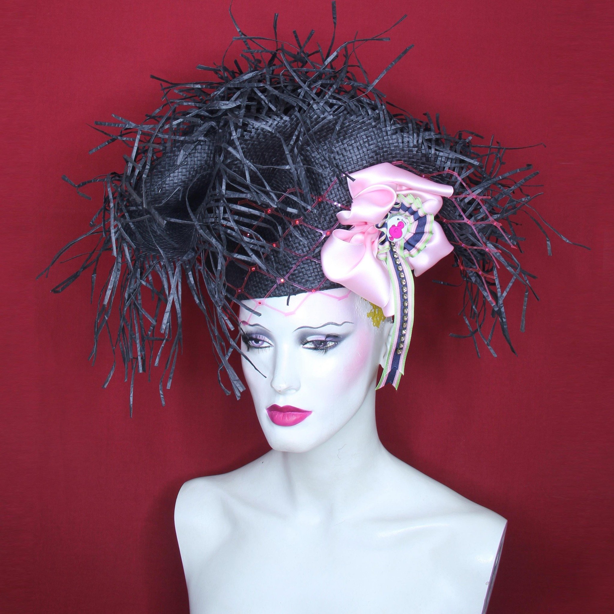 Collection 31.
#workinprogress 
Unused stock: black paper capeline with unfinished brim, folded up into an unequal tricorn, fitted to head on partially inverted crown. Wired and stiffened, no cutting. Decorated with a silk and grosgrain ribbon cockad