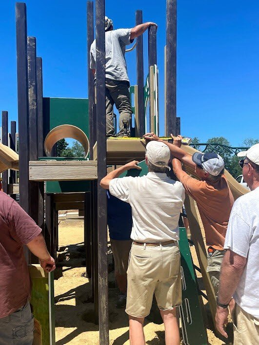 community volunteers installing a play structure (1).jpg