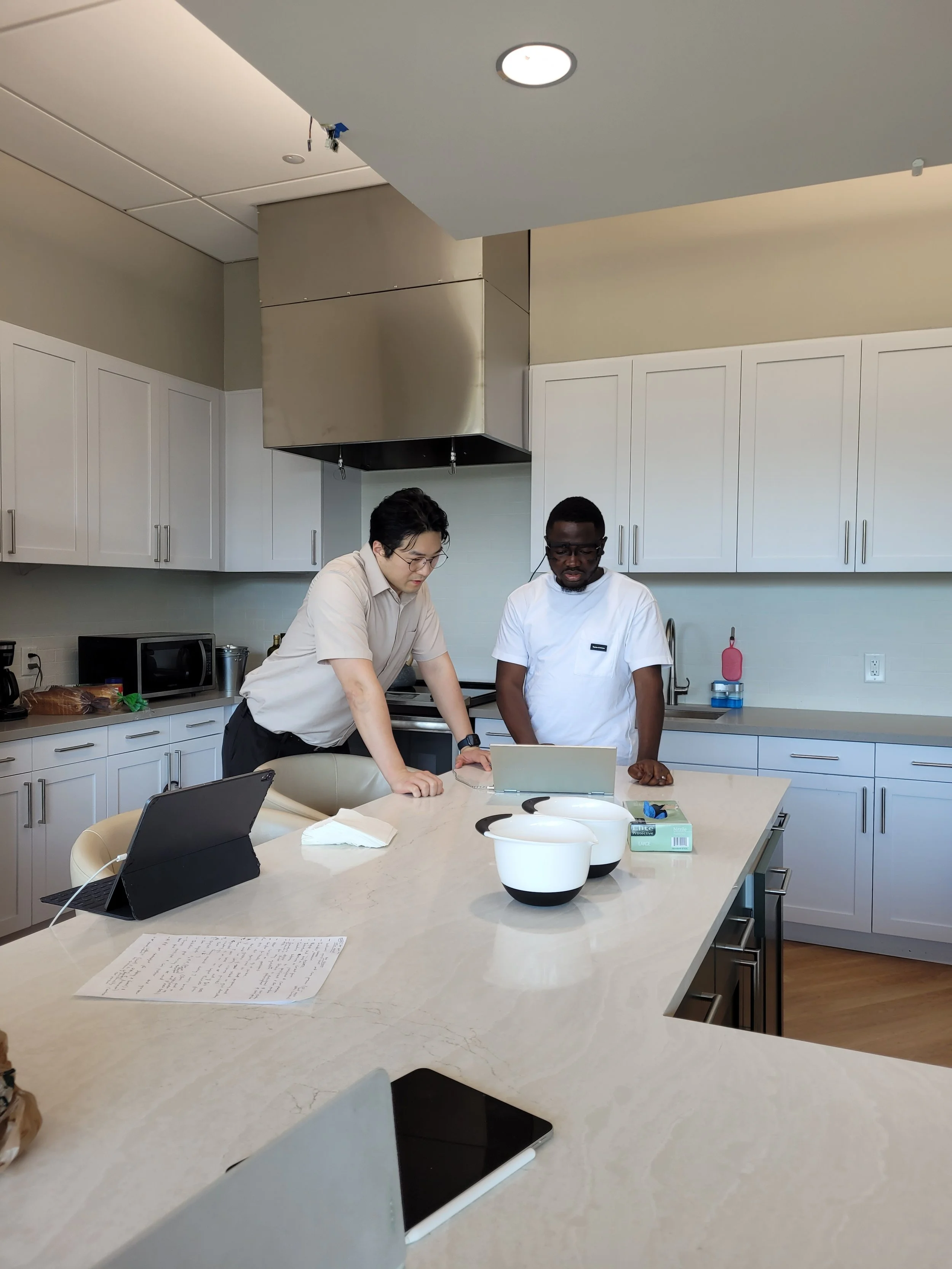 Ibrahim Bilau, with Emory University Assistant Professor, Dr. Hyeokhyen Kwon, at the Charlie and Harriet Shaffer Cognitive Empowerment Program facility, setting up for a kitchen study pilot test. Source: Ibrahim Bilau.