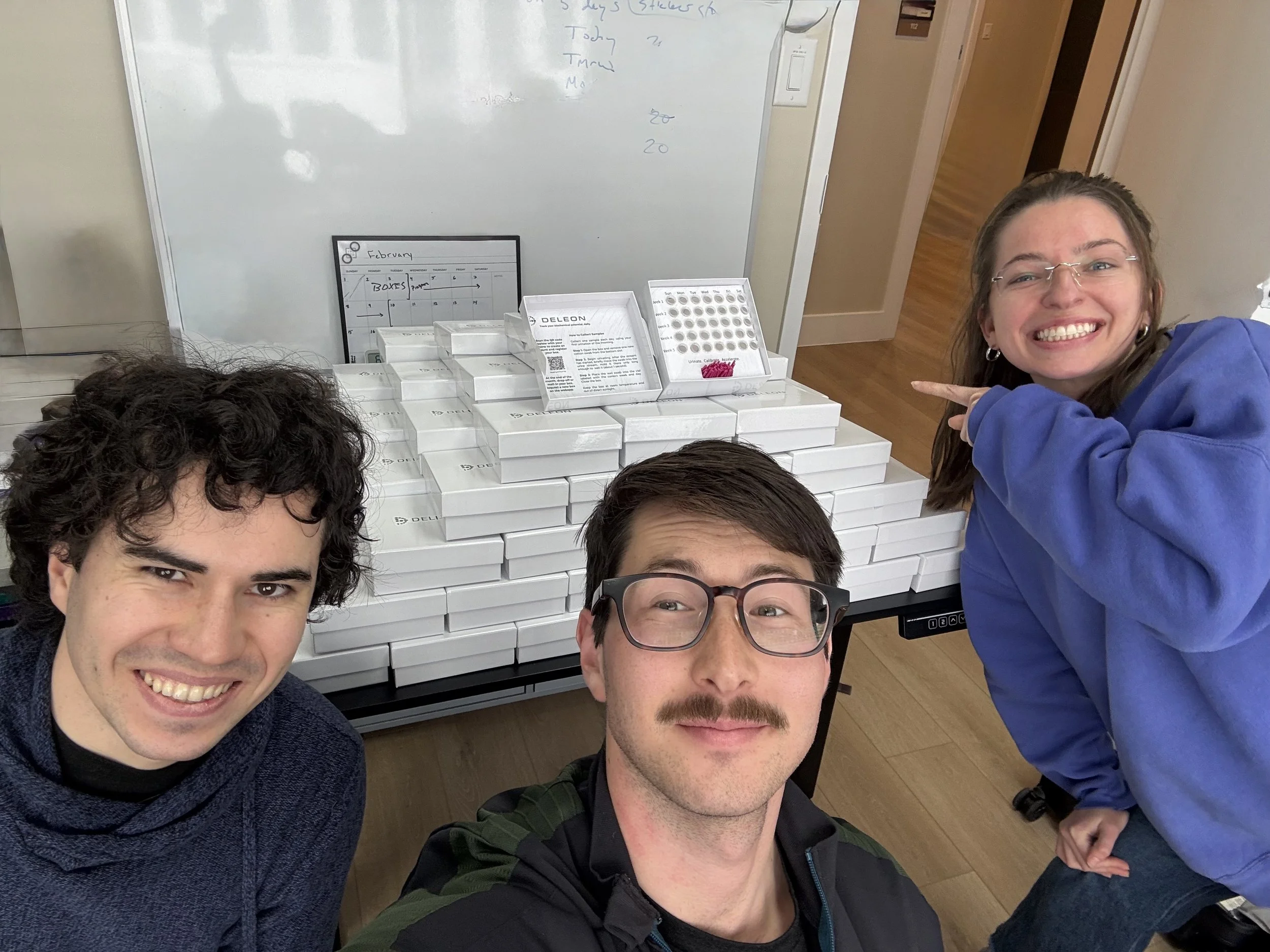 Photo of the Deleon team in front of the at-home metabolomics sampling kits. Source: Deleon Technologies.