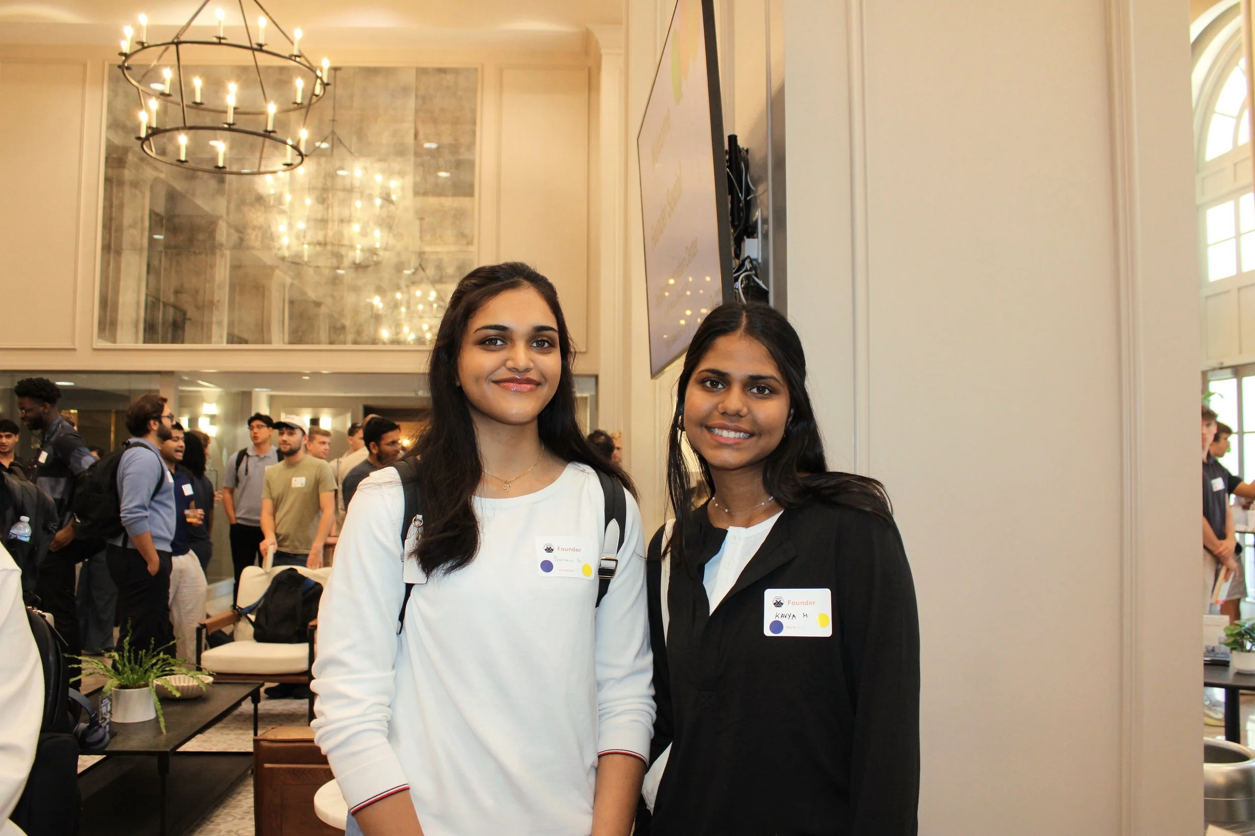 Kavya Mohankumar and Pranavi Gogineni at the Biltmore Innovation Center during a startup event. The Biltmore lobby is white, tan, and with a chandelier light. Source: Kintic.