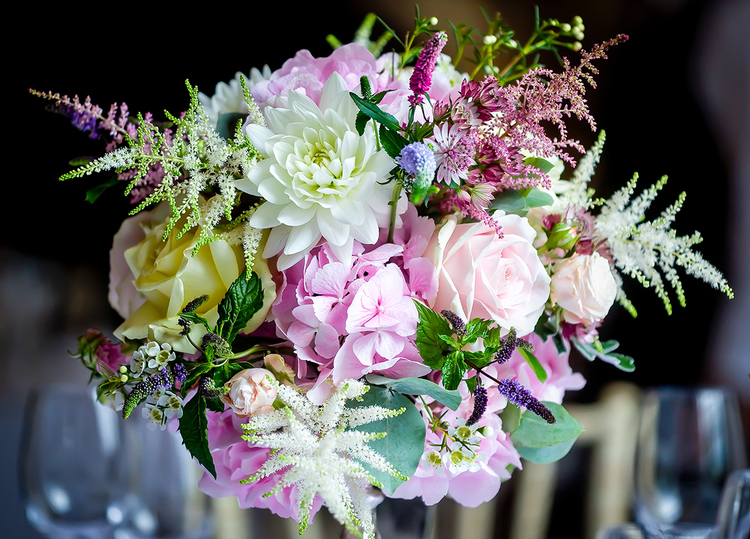 Wedding table centre with pink astilbe, hydrangea and cream roses