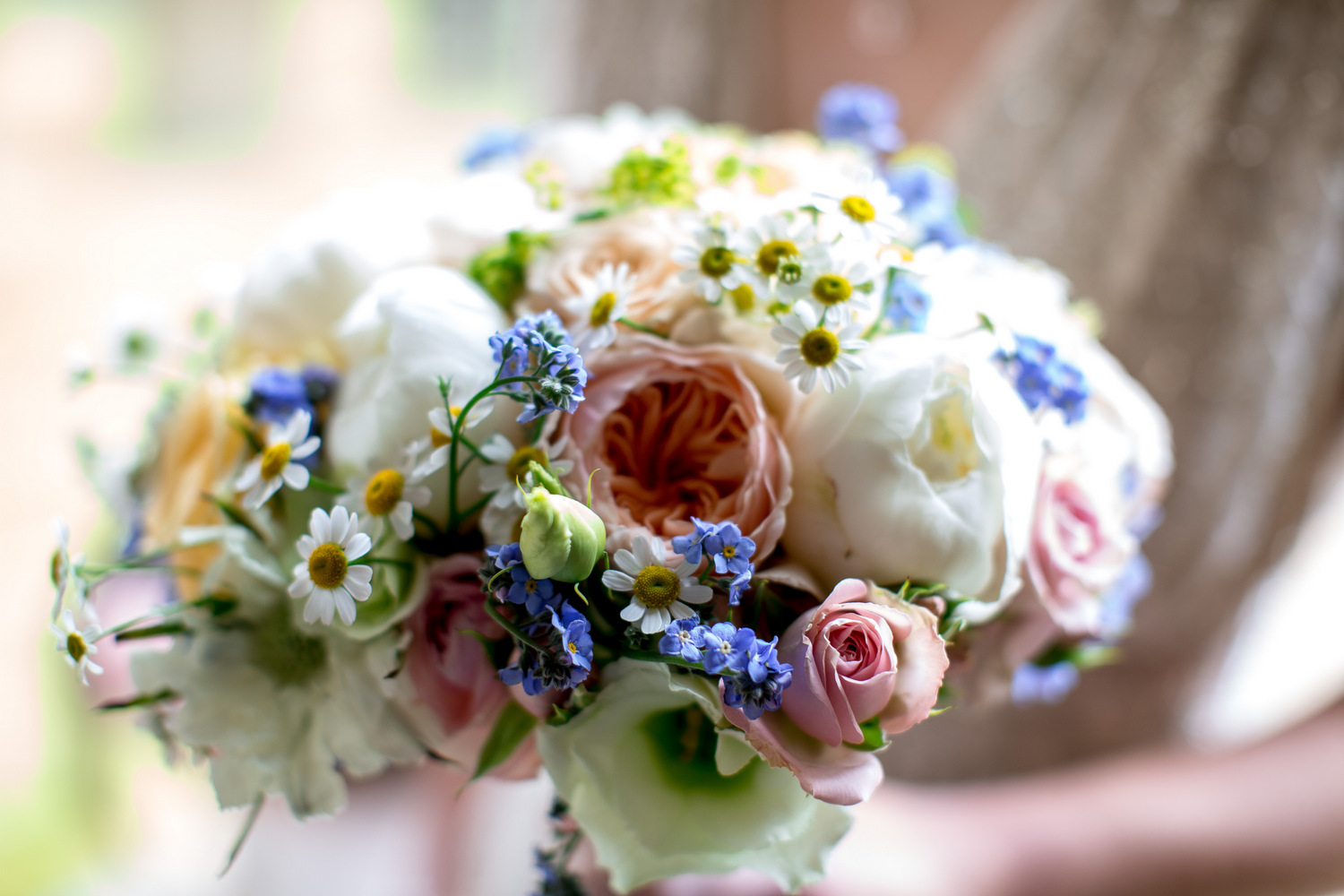 Pretty cream, peach and blue bridal bouquet.