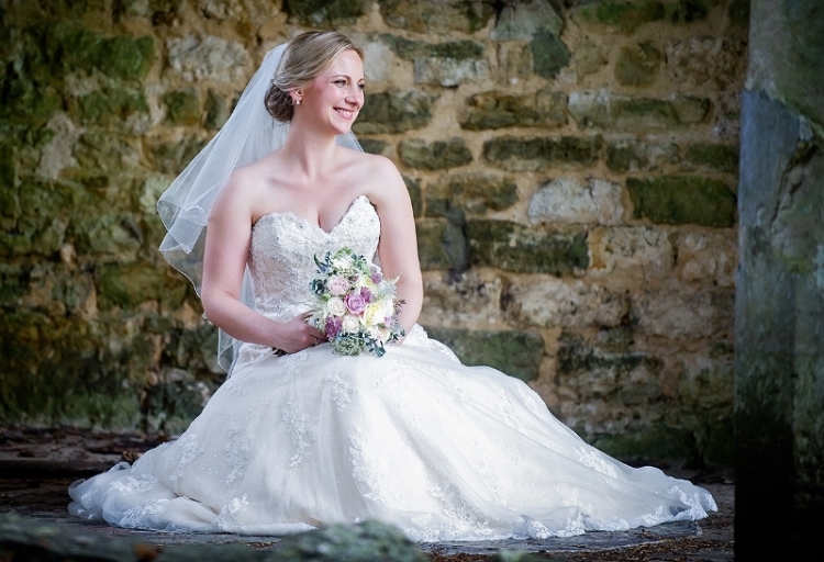 Summer bride with wedding bouquet in pink, cream and lilac