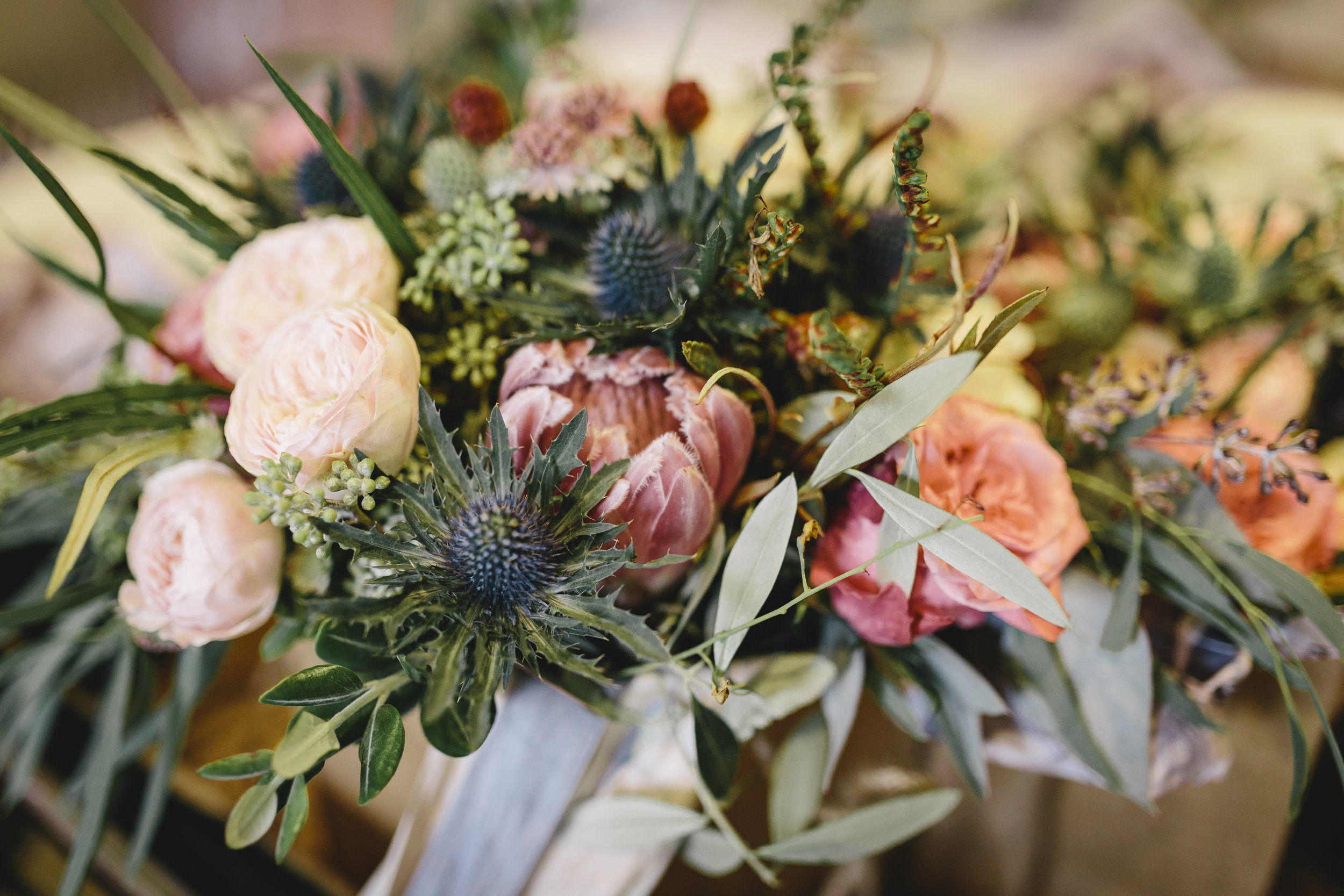 Bridal bouquet with protea, eryngium and roses