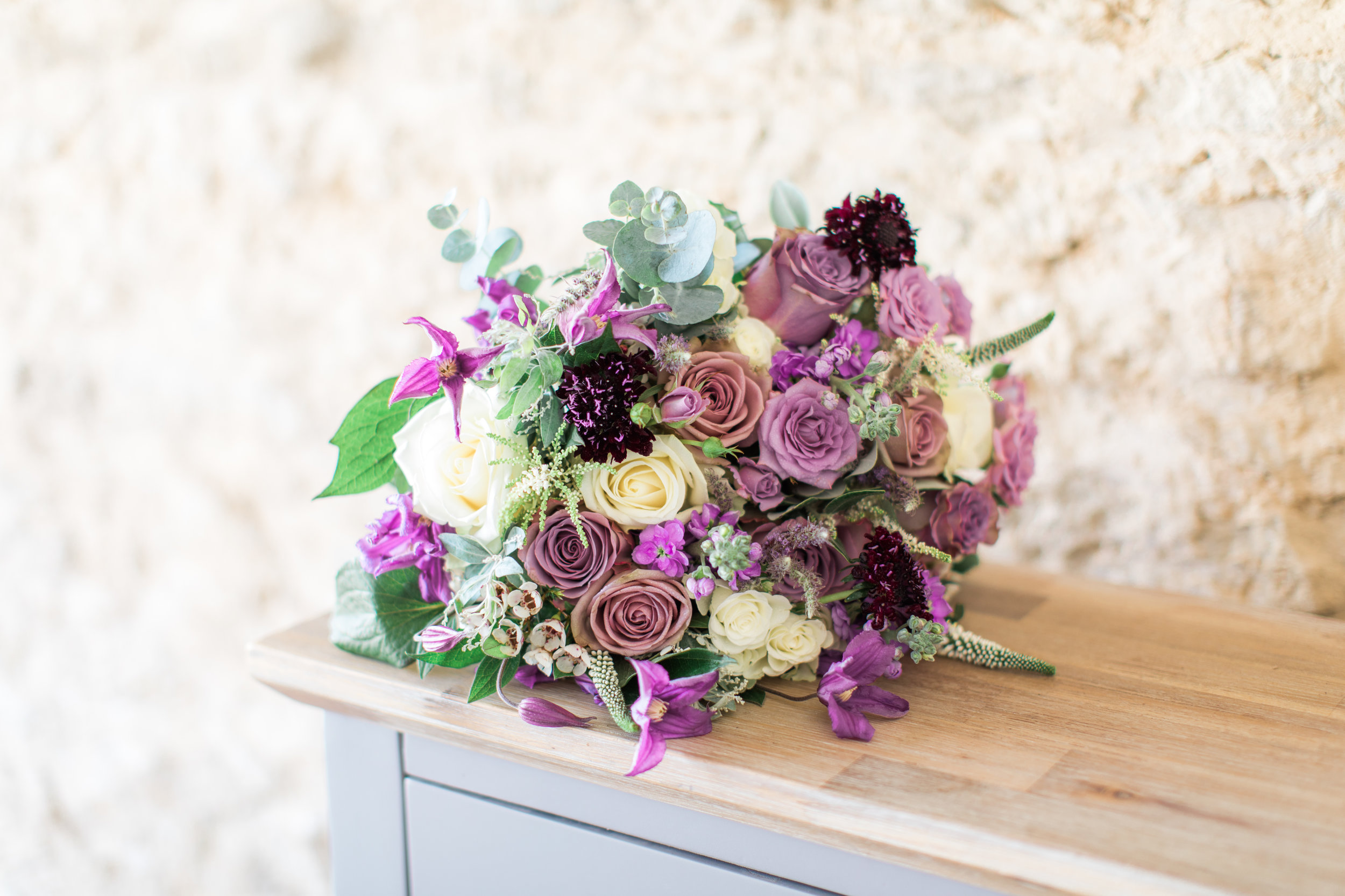 Lilac, cream and plum bridal bouquet at Stratton Court Barn, Oxfordshire