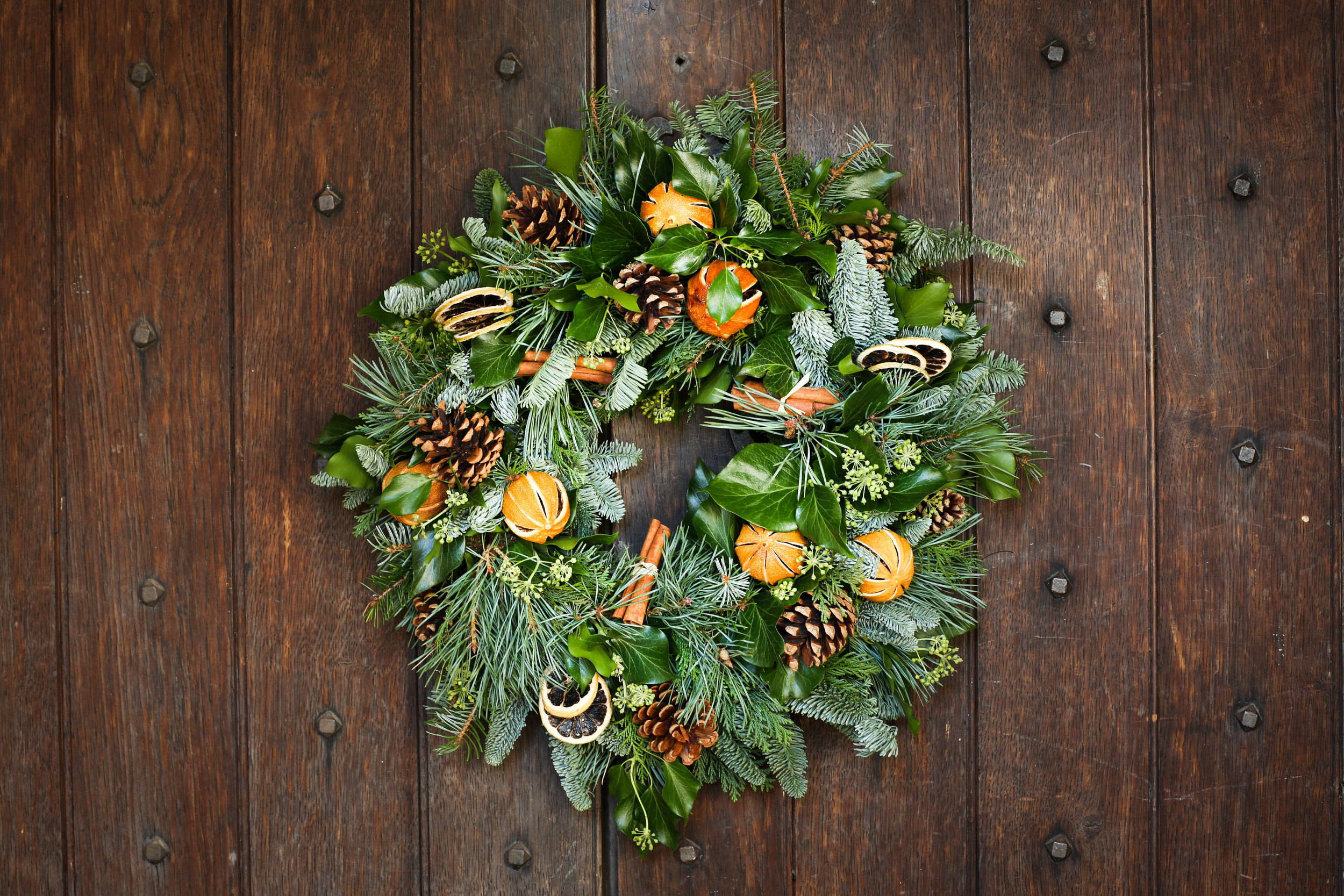 Christmas wreath with cones and oranges