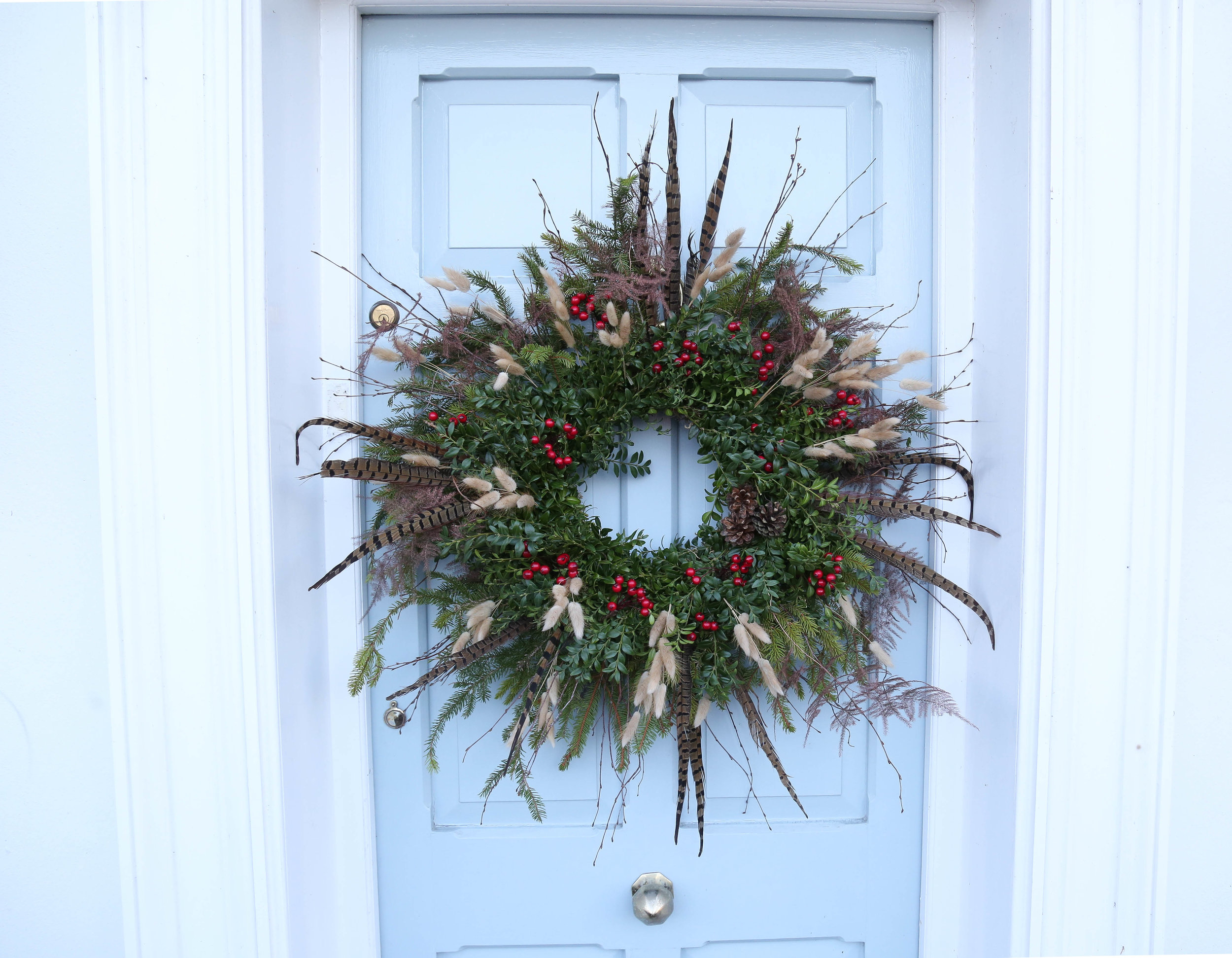 wild, rustic cChristmas wreath with pheasant feathers