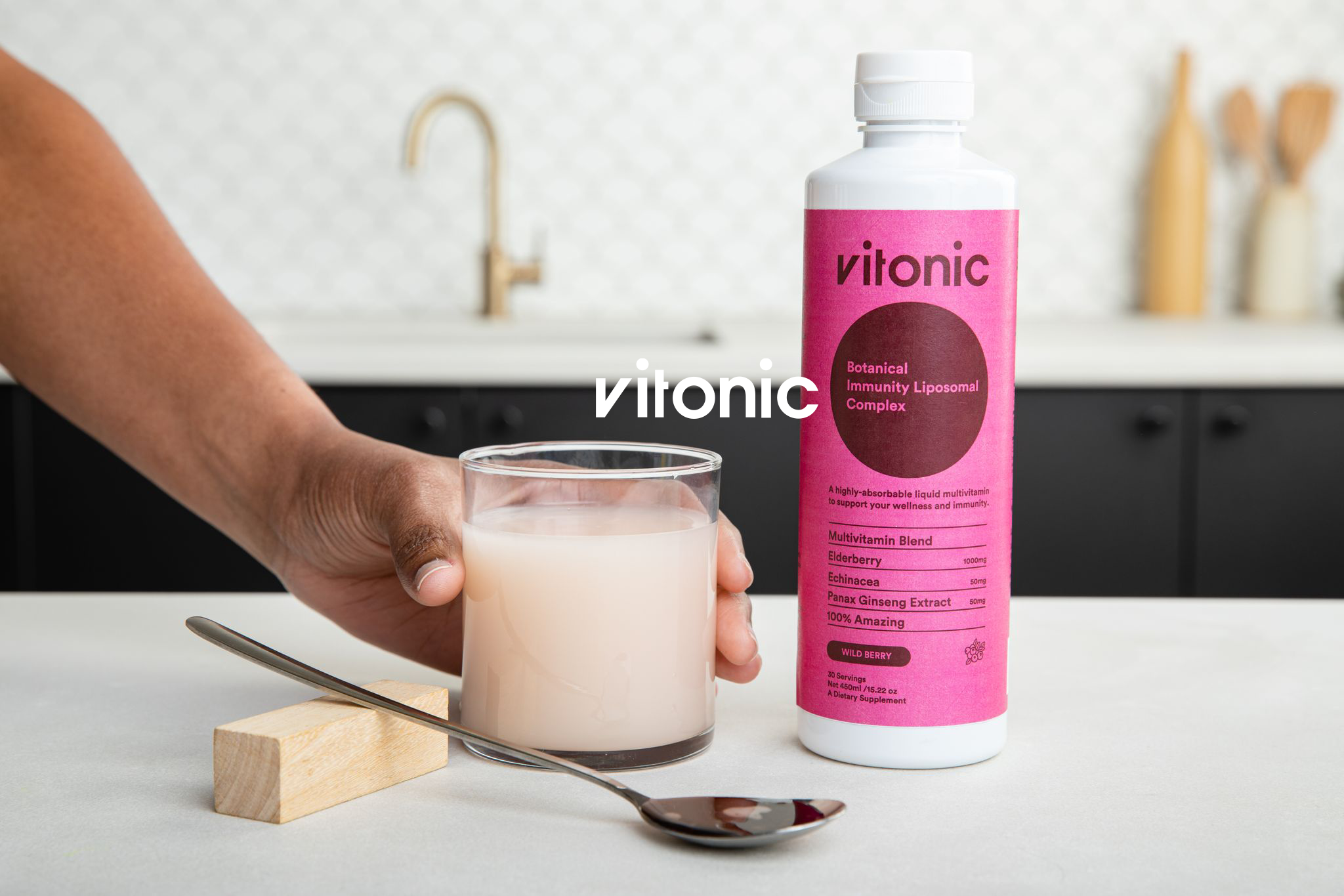 Botanical hand and bottle in kitchen.png