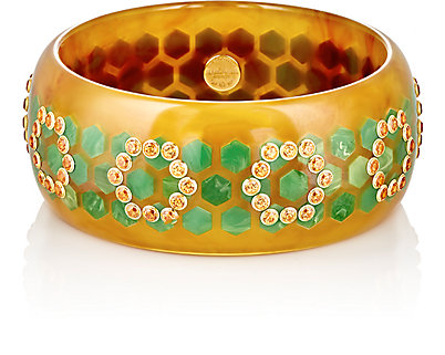 Vintage bakelite with round orange spessartite garnet set in 18k yellow gold bezels. Available from Barneys