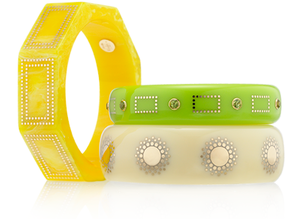 Bangles created from vintage bakelite with 18 karat gold wire inlay and peridot.