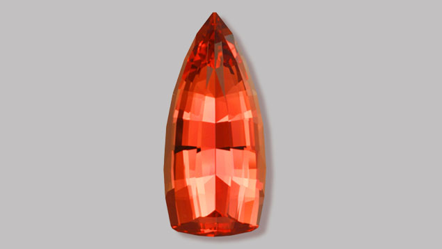 Spectacular prize-winning, orangy-red, flame-shaped Imperial Topaz gem. (Photo: Gem courtesy of John Dyer & Co.)