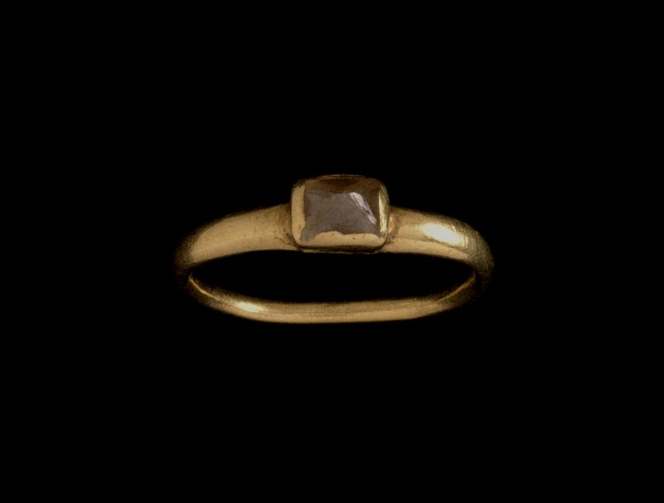  Gold finger-ring:&nbsp;thin rounded hoop, slightly expanding upwards with a rough brown diamond. 3rd C Roman. The British Museum Collection. 