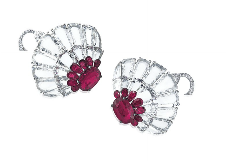  A pair of ruby and diamond earrings by Bhagat. Stylised lotus flowers with central rubies surrounded by flat diamond petals. 
