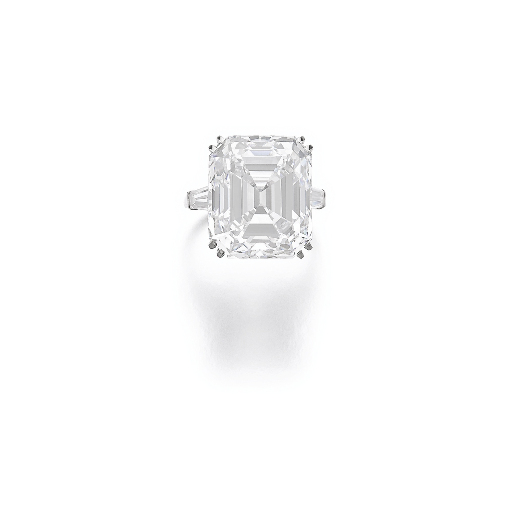  Important diamond ring by Van Cleef &amp; Arpels. Set with a step-cut diamond weighing 21.60 carats, between tapered baguette diamonds. 