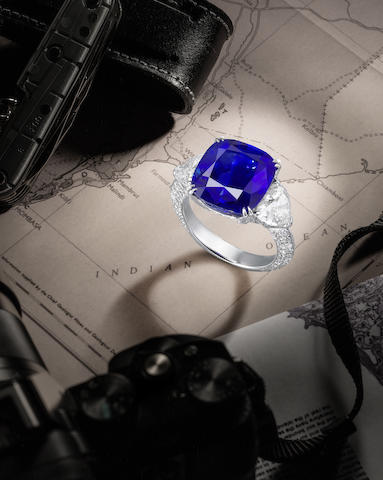  A Fine Natural Sapphire and Diamond Ring. The cushion-shaped sapphire, weighing 10.83 carats, between heart-shaped diamond shoulders, the gallery and hoop pavé-set with brilliant-cut diamonds, diamonds approximately 3.05 carats total, ring size 6½ 