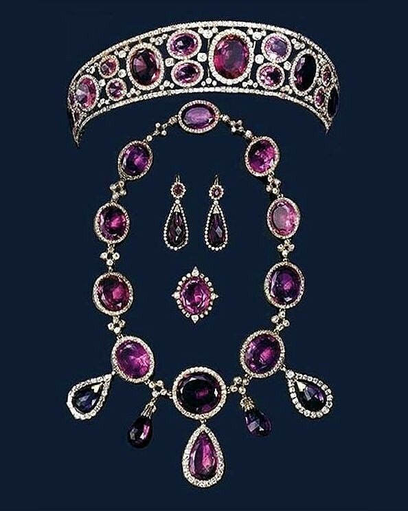 Queen Mary's Amethyst Parure was a set that the jewelry loving queen purchased through auction. It included a collection of large, primarily oval-shaped, amethysts surrounded by diamonds. 
Mary passed the set on to her daughter-in-law Elizabeth who n